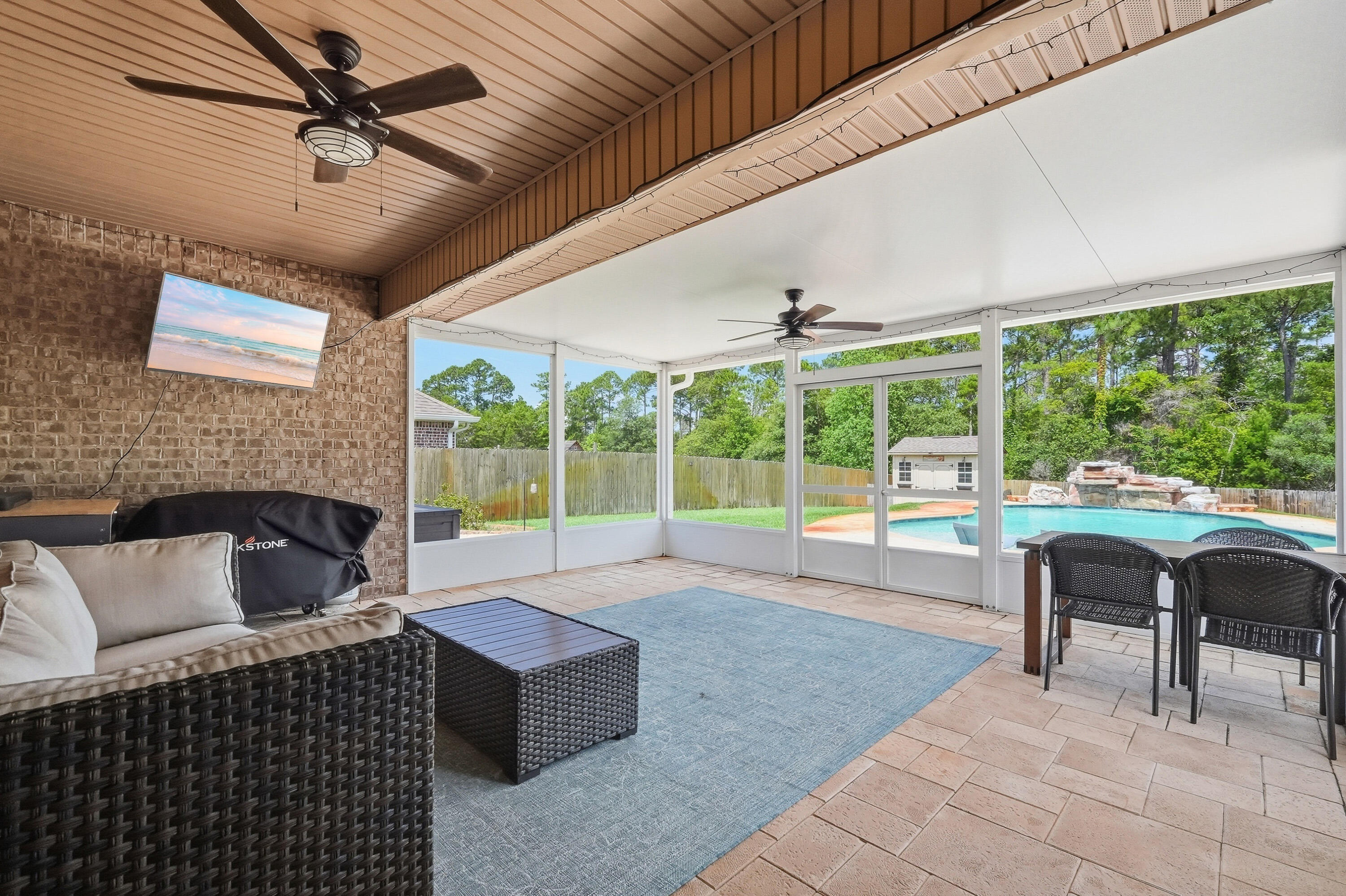 Summer is HERE, and your backyard oasis  awaits!  Experience the perfect blend of comfort, style, and outdoor living in this beautifully updated, 4-bedroom, 2.5 bathroom, brick home located in Treasure Isle Estates. This home is located only MINUTES to the emerald colored water and white sand of Navarre beach, public boat launch access, restaurants, shopping and so much more. Designed with a desirable split and open concept floor plan, this home showcases soaring double tray ceilings, crown molding, luxury plank flooring throughout, and abundant natural light from oversized windows overlooking the backyard retreat. 

The spacious living area centers around an inviting electric fireplace, while the roomy kitchen features a large island, granite counter tops, backsplash, custom built pantry with pull out drawers and baskets, and a convenient spice rack mounted on the pantry door.

The owner's suite offers a luxurious custom walk-in closet with adjustable shelving, providing exceptional organization and storage. The owner's suite bath features a double vanity, a large garden tub perfect for relaxing after a long day, and a standalone tile shower, convenient for those days on-the-go.  

Step outside to your private backyard oasis for a swim to cool off on those hot summer days.  Enjoy a stunning Gunite saltwater pool with a fountain, controlled directly from the Pentair app, along with a newly installed screened entertainment room (2025) all connected to the covered patio. Complete with a wall-mounted TV, ample seating areas, a fire pit, and solar-powered motion activated lighting for added convenience, the outdoor space is ideal for relaxing or hosting family and friends. The fully fenced backyard also includes a storage shed for all of those outdoor tools, toys, and pool accessories. 

Additional features include a covered front porch, decorative front water feature, video doorbell system, extreme weather window coverings, dedicated laundry room, and a 2-car garage equipped with ceiling-mounted storage shelving. Significant upgrades include a Culligan water softener and reverse osmosis system installed in 2023, a transferable termite bond established in 2023,  a Nest programmable thermostat, and fresh interior paint completed in 2024. Underground utilities add to the clean curb appeal and convenience of this exceptional property.

From the thoughtful custom storage solutions to the resort style outdoor amenities, this move-in-ready home offers everything you need for comfortable everyday living and effortless entertaining.

Don't wait. This is home!

Buyer(s) is responsible for verifying ALL data and information, including lot size and room measurements, as it is deemed to be reliable but not guaranteed.