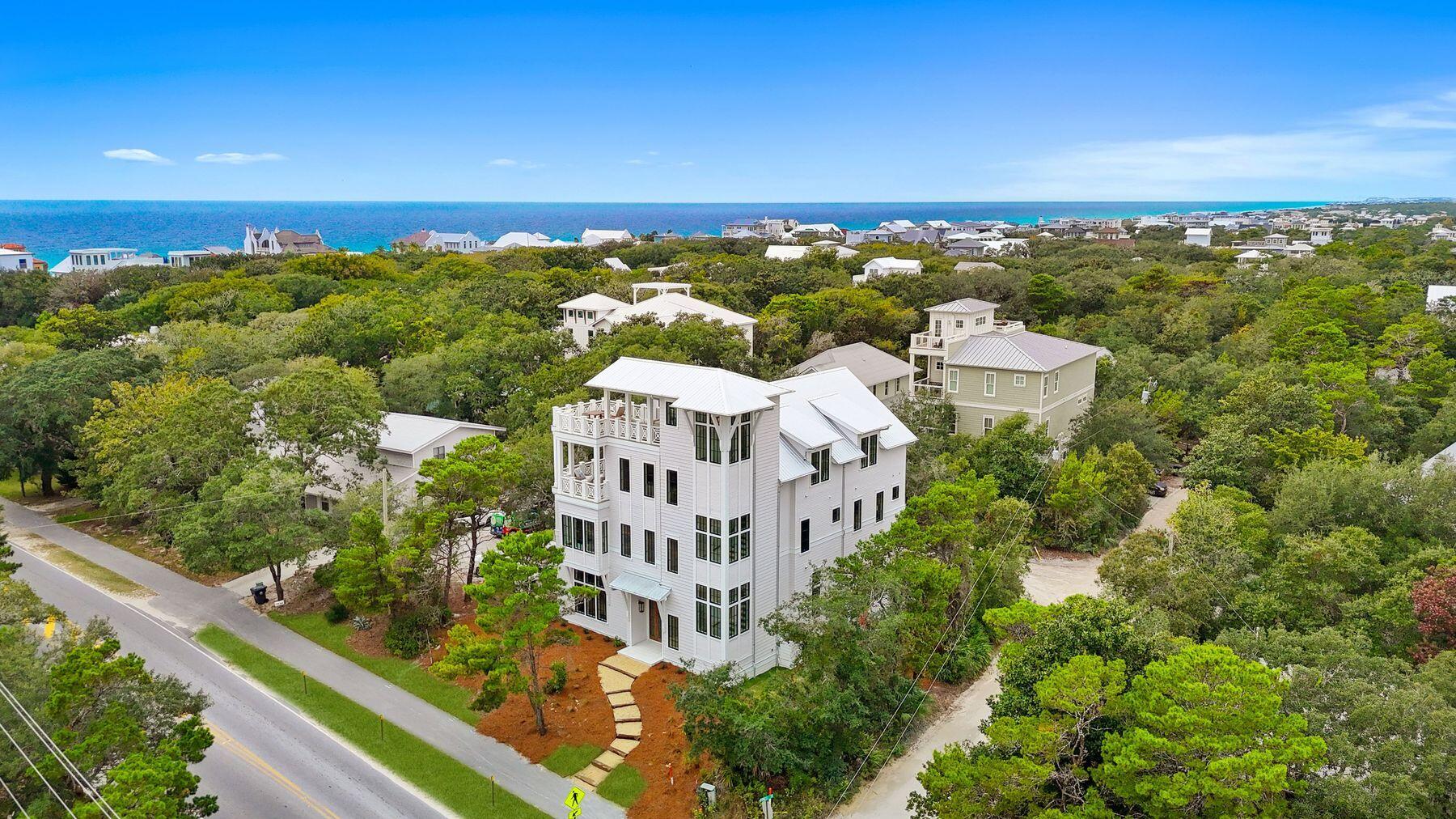Where Coastal Luxury Meets Elevated Design:
This exceptional retreat in Old Seagrove seamlessly blends architectural sophistication with timeless coastal style. The 5,283 sq. ft. residence is offered fully furnished and showcases five bedrooms, including three primary suites, two guest suites, a bunk room, media room, and 6.5 baths.
Step through the grand entryway into a light-filled foyer with soaring 12-foot ceilings, setting the tone for the remarkable design within. The gourmet kitchen impresses with Wolf and Sub-Zero appliances, a stone slab backsplash carried all the way to the ceiling, and a generous island perfect for entertaining. The kitchen flows seamlessly to a sitting area and open living room, continuing into a grand dining space just steps from your private wine storage. Completing the first floor is one of two primary suites, adorned with custom cypress ceilings and a spa-like bath.
The second floor welcomes you with a spacious landing that leads to a second primary suite with tranquil, spa-inspired finishes and separate soaking tub, an additional guest suite, a media room, bunk room, and an oversized screened porch tucked beneath the oaks  the perfect retreat for coastal evenings.
On the third floor, a secondary living space awaits  complete with a built-in beverage center for effortless entertaining  connecting to a third primary suite option, an additional bedroom, and an expansive outdoor terrace. As you ascend to the fourth floor, you're greeted by an abundance of natural light and a dramatic chandelier, leading to the rooftop deck  a show-stopping perch above the treetops, offering panoramic Gulf views and sweeping coastal vistas.
Designed for indoor-outdoor living, the home features over 1,000 sq. ft. of porches, a private pool and spa, elevator, and wide-plank oak flooring throughout. Every finish and fixture reflects a commitment to quality and sophistication.
Perched on one of Old Seagrove's highest natural elevations  rising 40 feet above sea level  the property offers a rare vantage point with Gulf breezes, serene views, and convenient access to Seagrove's sugar-white sands. Residents enjoy plenty of room to unwind and take in the emerald waters of the Gulf.
In collaboration with NOLA 30A, Fox Construction, Stackable + Mracek, and Design and Dwell, this home represents a masterclass in coastal design, crafted for those who appreciate artistry, architecture, and effortless living.