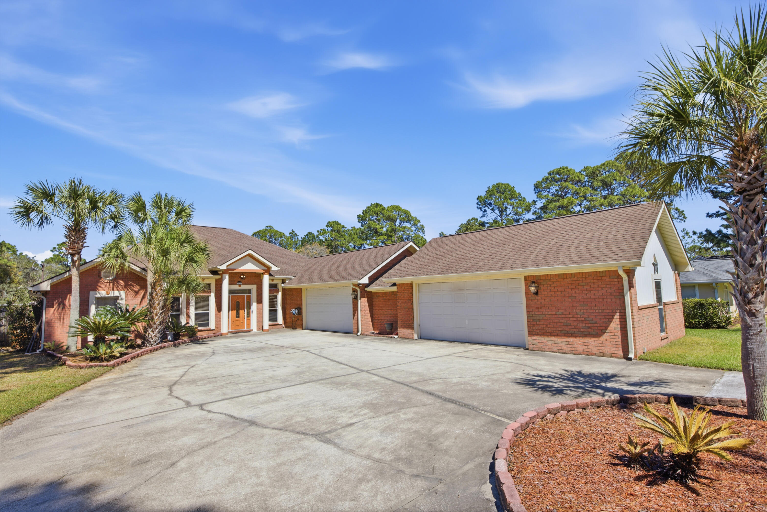 This 4-bedroom, 3-bath home offers 2,670 square feet of heated and cooled living space, set on 1.86 acres with 300  feet of river frontage. The in-ground pool is fully enclosed with a screen, easy to maintain and enjoy year-round. A new hot tub adds to the outdoor living experience. The large, newly built dock with a floating platform gives easy access to the river, perfect for boating and fishing. Inside offers an open kitchen and living area for everyday living and entertaining. The kitchen has plenty of space and storage, with smart  appliances. Primary bedroom suite includes a jetted tub and large walk-in closet. The 3 add'l bedrooms are spacious and situated on the opposite side of the house. All-brick exterior, attached garage with space for up to five cars, oversized out building. with an attached carport provides extra storage or workspace. With plenty of space, and water access offering a great opportunity to create your ideal riverfront home. Make an appointment to view today!