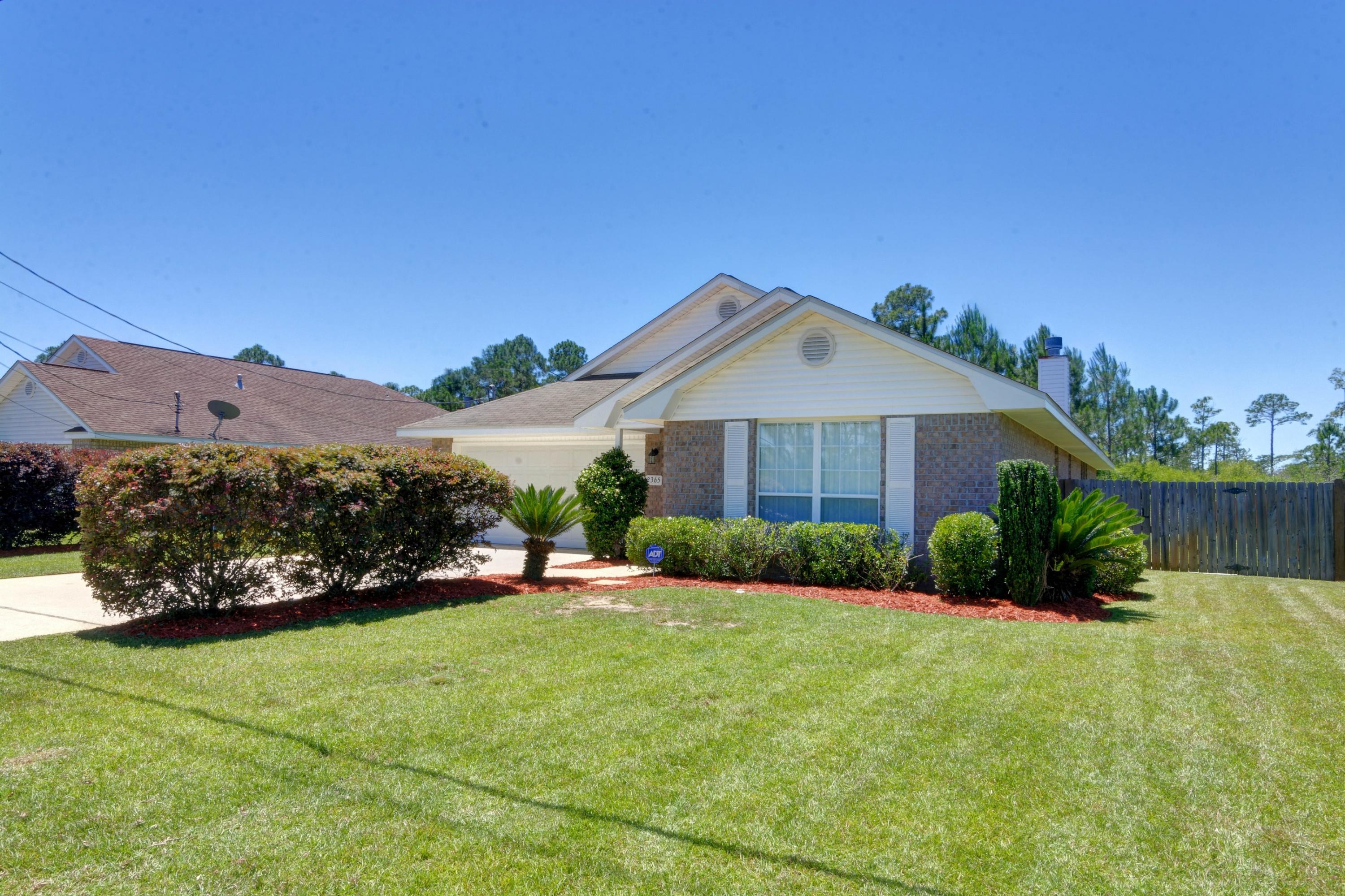AWESOME HOME AT A GREAT PRICE AND SUPURB LOCATION!! This 4bed/2bath home features high ceilings, new carpet throughout, open floor plan, lots of natural light and very spacious kitchen with large breakfast bar, stainless appliances, refrigerator and walk in pantry. The master suite features access to the rear covered patio and bath with double vanities, walk in closet and separate soaking tub and shower. Situated on a spacious lot that backs to a wooded area for additional privacy and fenced back yard. This home also offers a spacious covered rear patio and hurricane shutters. You are within walking distance to Navarre high school and the Navarre Youth Sports Complex, in addition you have the benefit of sidewalks & underground utilities. Priced to sell and ready to close quickly!