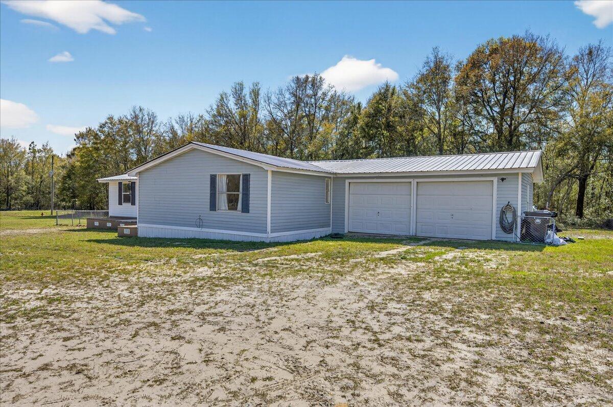 Move-in ready home situated on 2.3 cleared acres, offering plenty of space to enjoy peaceful country living. The home features a 2-car garage along with a spacious living room and bedroom addition, providing added flexibility and room to spread out. Inside, you'll find durable laminate flooring throughout, updated bathrooms, and neutral paint that creates a clean, inviting feel. A metal roof adds long-term value and durability, making this property a great option for those looking for both comfort and functionality.

Outside, the fully cleared acreage is perfect for farm animals, outdoor hobbies, or riding ATVs, and includes a fenced yard for added convenience. Enjoy the peace and privacy of rural living while still being just a short drive to Hwy 90, Niceville, DeFuniak Springs, Crestview and the beautiful white-sand beaches of the Emerald Coast.