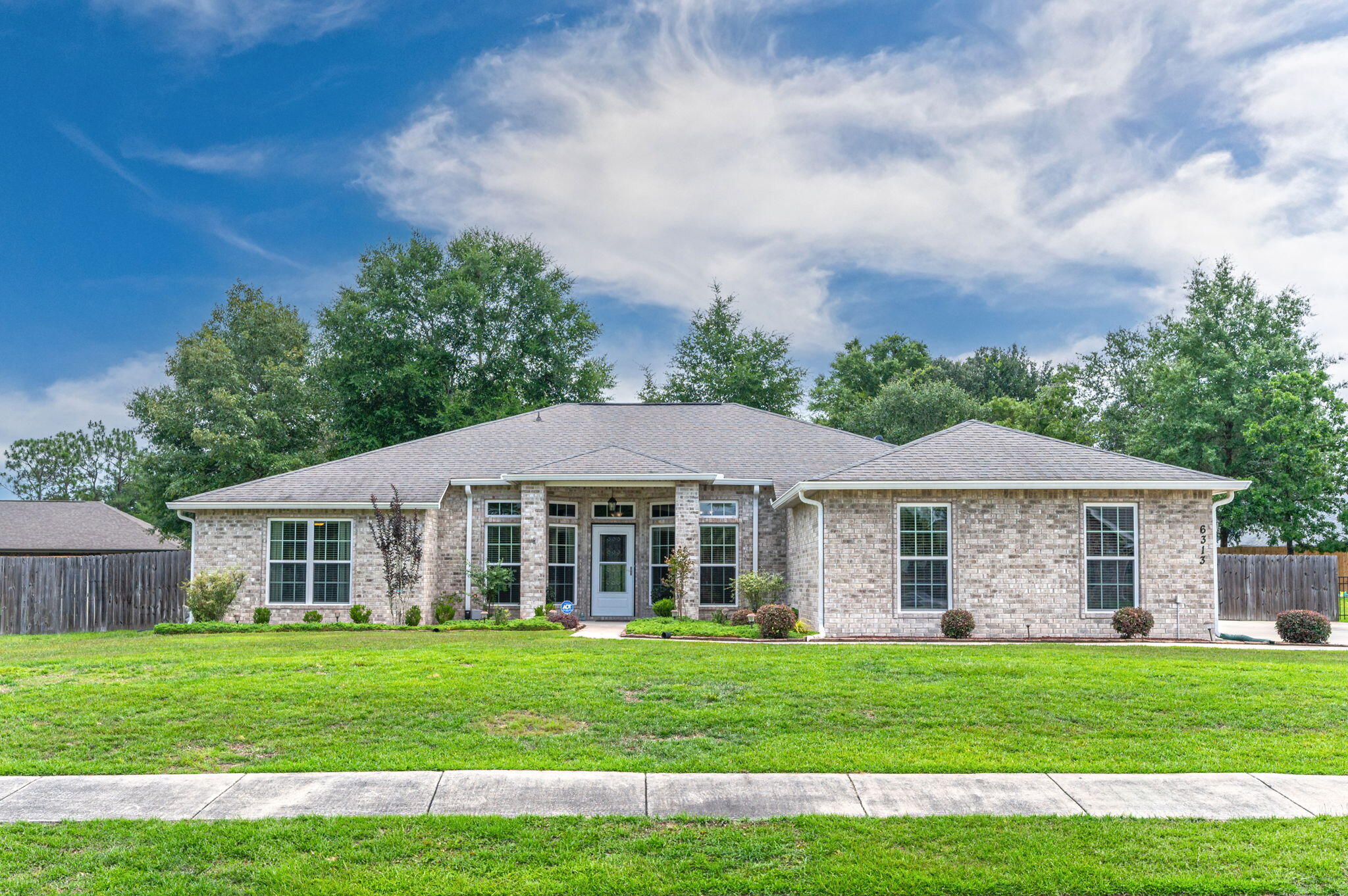Welcome to this beautifully maintained all-brick 4 bedroom 3 bath home offering the perfect blend of comfort, style, and functionality. Situated on a spacious lot with exceptional curb appeal, this property features a welcoming covered front porch, manicured landscaping, and an oversized driveway leading to a side-entry 3-car garage. Step inside to discover an open-concept floor plan with soaring ceilings, abundant natural light, and durable luxury vinyl flooring throughout the main living areas. Just off the foyer, a dedicated office with glass French doors provides the perfect work-from-home space or flex room. The heart of the home is the spacious kitchen, featuring granite countertops, stainless steel appliances, a center island, abundant cabinetry, tile backsplash, and a large breakfast bar overlooking the living and dining areas. The open layout makes entertaining effortless while keeping everyone connected. The expansive living room offers plenty of space for gatherings and flows seamlessly to the dining area and an extensive covered rear patio. The thoughtfully designed split-bedroom floor plan provides privacy and functionality for family and guests alike. The primary suite serves as a private retreat and you need to  check out those closets~ Wow~ while additional bedrooms offer generous space and versatility. Throughout the home, you'll appreciate the neutral color palette, recessed lighting, and well-maintained finishes.  ( con't) Outside, enjoy the sprinkler system and fully fenced backyard with room for pets, play, gardening, or future outdoor amenities. The oversized driveway provides ample parking for guests, recreational vehicles, or additional vehicles. The yard building will hold all your exterior tools, storage. This meticulously maintained home offers the space, features, and curb appeal today's buyers are looking for. Schedule your private showing today and experience all this exceptional property has to offer!