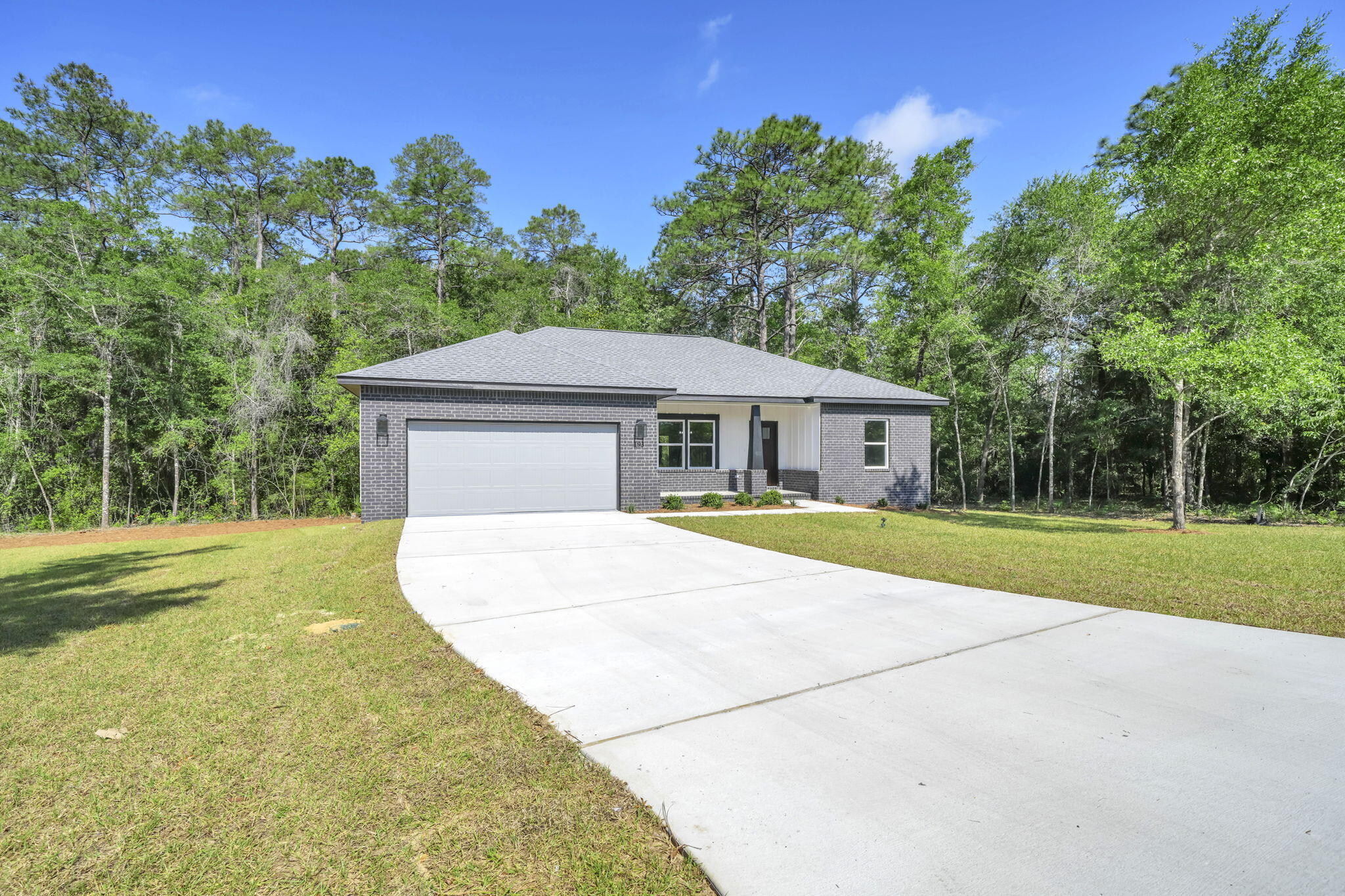 BRAND NEW CONSTRUCTION! IDEAL LOCATION! MOVE IN READY! This new home is perfectly situated in the community of Hunter's Ridge located directly behind Walton High School with close proximity to city parks and Downtown Defuniak Springs. Hunter's Ridge boasts; underground utilities, countless trees, and public water/sewer. Enjoy the comfort of the split bedroom floor plan. Interior features include; LVP (luxury vinyl plank) flooring in the main living areas, tiled bathroom floors, stainless appliances, solid surface countertops, high-grade mill work, custom shelving in closets/pantry, and a plethora of recessed, can lighting/designer light fixtures. Exterior features; architectural brick and fiber cement siding, wooden tongue and groove stained entry ceiling at front porch, two-car garage, and 3 dimensional roof shingles. Make 183 Hunters Ridge Drive your brand new Florida address!!