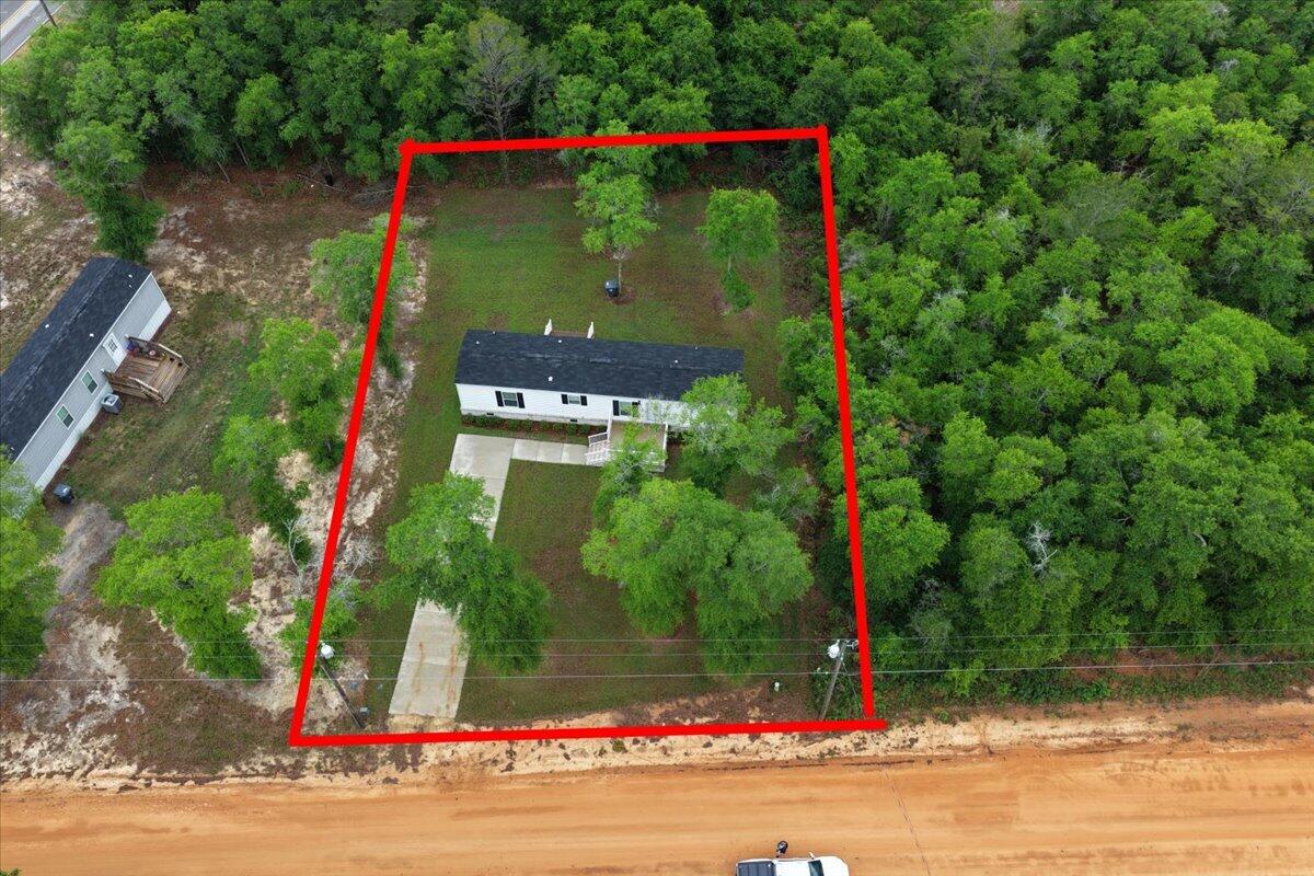 Upgraded 2BR/2BA manufactured home, 728 sqft, featuring upgrades beyond the standard build. Enjoy sheetrock walls throughout, wood trim and baseboards, and seamless linoleum flooring for a clean, finished look. Both bathrooms offer ceramic sinks, and the kitchen includes a dining area for everyday convenience. Front and back doors have reinforced frames with added strike plates for extra security.

A walk-through utility room with washer/dryer hookups leads to the back deck overlooking a nicely sodded backyard. Energy-efficient heat pump HVAC system in place. Home is set on full brick skirting, adding durability and a more refined appearance.

Exterior features include a concrete parking pad with sidewalk access to the front porch for easy entry.