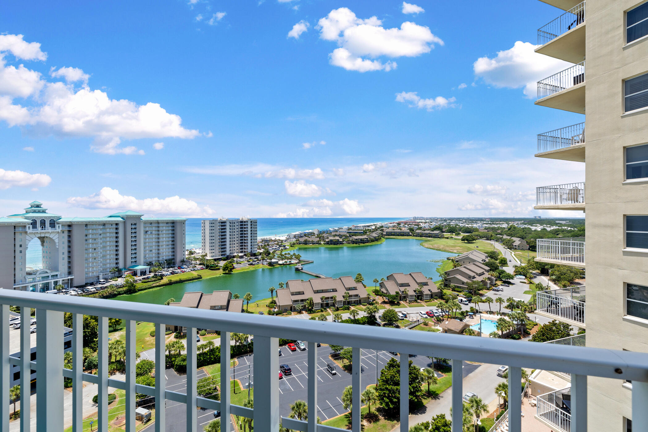 One of only a handful of west-end Corner units in Ariel Dunes I, this spacious 3 Bed / 3 Bath 14th-floor residence offers a view that simply cannot be duplicated! The expansive wraparound balcony showcases emerald Gulf waters, resort lake, and unforgettable sunsets all the way to the Destin bridge, while the second balcony off the guest bedroom overlooks the bay, golf course and Seascape's exciting new entertainment districts. Natural light pours through walls of windows highlighting the recently updated interior featuring beautiful LVP flooring, a custom built-in bar, stylish coastal furnishings, and an open-concept floor plan that's completely turnkey for vacation rentals, a second home, or full-time coastal living.  Located within the gated Seascape Resort, owners enjoy easy access to sugar-white beach, an 18-hole golf course, multiple pools, gym, an active tennis and pickleball community, walking and biking trails, on-site dining/ shopping and the vibrant Seascape Towne Centre all without leaving the resort.