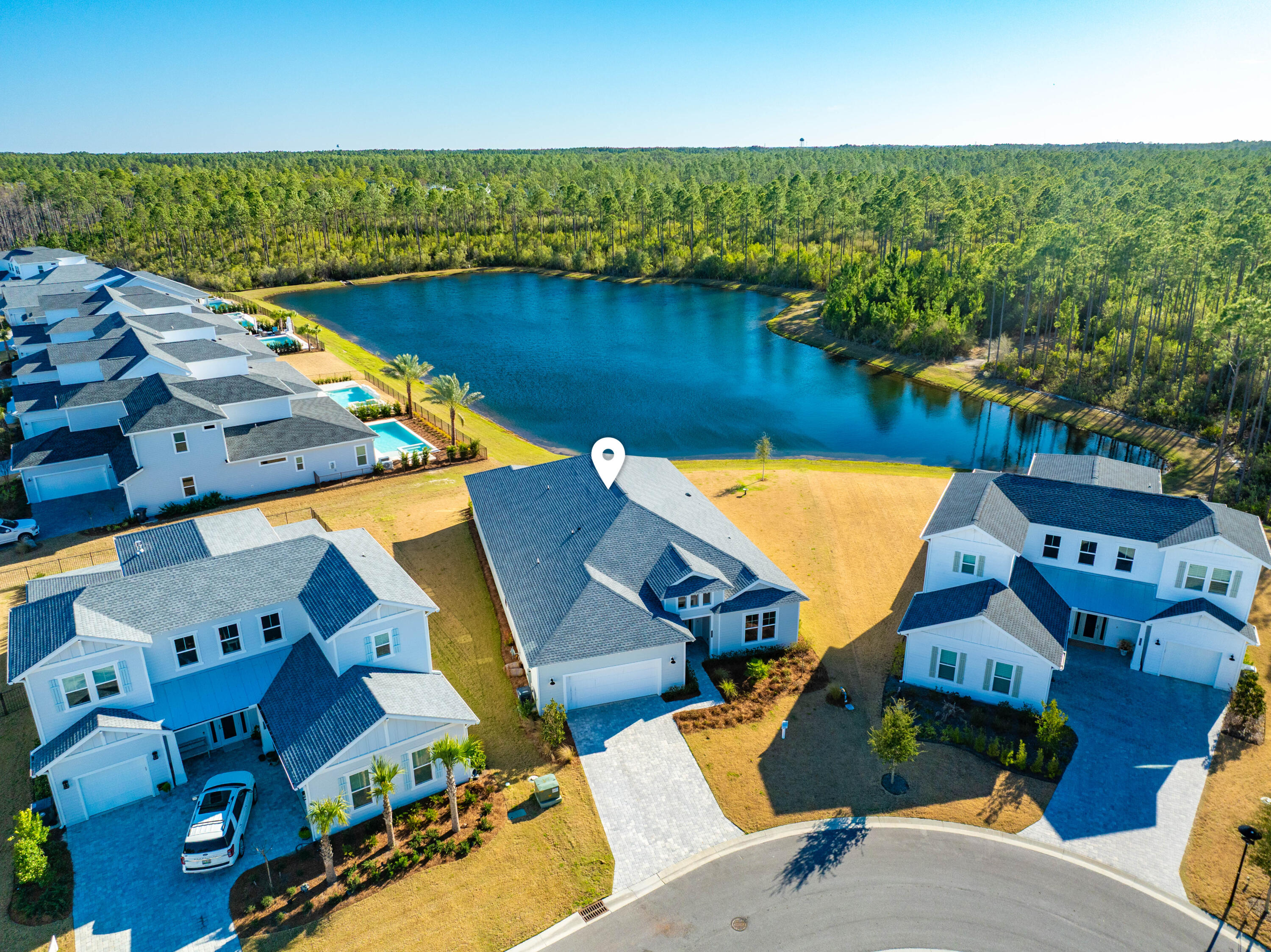 Welcome to 2552 Pathways Drive -- a stunning new construction home nestled in the heart of WaterSound Origins, the most sought-after gated community along Scenic 30A in Inlet Beach, FL.
This is not your standard build. Featuring a specially expanded floor plan, this exceptional 4-bedroom, 3-bathroom residence was designed to deliver a grander and elevated living experience from the moment you arrive. Step through the grand entry foyer and immediately feel the difference. Soaring high ceilings, rich engineered hardwood floors, premium interior finishes, and a spacious open-concept layout that flows effortlessly throughout the home. The large chef's kitchen is the heart of the home, designed for both everyday living and effortless entertaining.  Every detail reflects the care and craftsmanship that went into this specially curated, expanded design -- from the engineered hardwood floors underfoot to the elevated finishes that set this home apart from anything else in the community.
The bathrooms are nothing short of luxurious. Each is beautifully tiled with features like sleek rimless glass enclosure, elevating the everyday experience. The expanded primary bathroom is a true sanctuary -- a spa-inspired retreat featuring a luxurious walk-in shower with a rimless glass enclosure. The primary bedroom boasts stunning panoramic lake views that transform your morning routine into something truly extraordinary. This is the kind of primary suite you'd expect at a five-star resort, right in your own home.
Step outside and experience the ultimate backyard setting -- an oversized covered porch perfectly positioned to frame peaceful lake views, lush nature, towering trees, and those breathtaking Florida sunsets. With ample yard space ready for a custom pool, the outdoor living potential here is simply unmatched.
Beyond your doorstep, WaterSound Origins delivers resort-style living at its finest -- featuring a Village Commons with a resort pool, fitness center, sports courts, parks, and scenic walking trails, plus direct access to Lake Powell with complimentary kayaks for residents. The Origins Golf Club is right within the neighborhood, and the growing WaterSound town center -- complete with a Publix, restaurants, and shops -- is just minutes away.