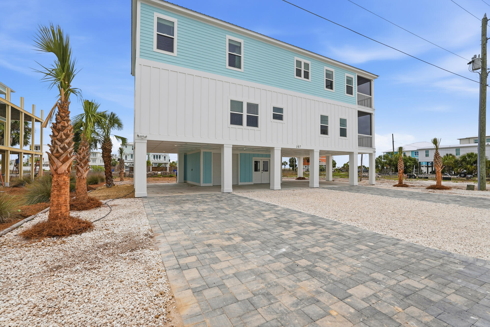 Discover coastal living at 107 Circle Drive, a custom-built, single-family residence located on the coveted beachside of Hwy 98 in Mexico Beach. This thoughtfully designed home has 4 generously sized bedrooms, 3-bath at approximately 3,368 square feet of living space, about 300 steps from the sugar-white sand and emerald waters of the Gulf. Designed for both full-time living and a low-maintenance beach retreat, the home features multiple living areas ideal for relaxing, entertaining, or working remotely. The efficient floor plan balances privacy and connection, while abundant natural light and Gulf views from many rooms enhance the home's beachside setting. The beautifully appointed kitchen features custom wood cabinetry and Frigidaire Gallery appliances, large laundry room with custom wood cabinetry. This custom-built single-family residence offers the privacy and flexibility today's coastal buyers are looking for -- no shared walls, no attached neighboring homes, and no HOA fees. Located on desirable Circle Drive in Mexico Beach positioned on one of the few quiet streets, this home is conveniently located removed from Highway 98 and still tucked away from road noise. Perfectly situated behind the marina, it offers peace, privacy, and that relaxed beachside feeling -- a true slice of coastal heaven. While short-term rentals are permitted, the area maintains a quieter coastal atmosphere that appeals to full-time residents, second-home owners, and vacation buyers alike.
This home offers enhanced storm resilience, covered parking, and dedicated storage areas. 
Built to current Florida coastal construction standards, the property also features impact-rated windows and sliding glass doors, elevated construction, a durable coastal-grade roof, covered parking with a garage door for golf cart storage, an outdoor shower, and convenient storage for beach and boating essentials.
Inside, the home features custom hardwood cabinetry in the kitchen and laundry room, along with upgraded closet systems throughout. Energy Star-rated systems and a tankless hot water heater with an instant recirculating hot water pump provide energy efficiency and near-instant hot water throughout the home. Positioned on one of the few streets in Mexico Beach that is not a straight front-to-back roadway, the property offers added ease for maneuvering boats, trailers, and golf carts. 

For all boaters out there, the City of Mexico Beach owns and rents out the Canal slips down the street. These slips are 12 feet wide, fitting almost all fishing boats, including boats with upper stations and towers. Call today!
Mexico Beach is beloved for its sugar-white sand, emerald water, and laid-back "Old Florida" charm without the crowds, high-rises, or heavy traffic found in larger beach destinations. The vibe is less "tourist hotspot" and more "coastal escape," where mornings begin with beach walks, afternoons are spent boating or fishing, and sunsets become part of your daily routine. 
Families, second-home owners, and vacation renters are drawn here for the slower pace, beautiful beaches, and strong sense of community. 
Conveniently located, Mexico Beach also offers easy access to Port St. Joe, Panama City, for dining, shopping, entertainment, and travel convenience.
Square footage does not include the additional 430 sq. ft. heated and cooled entry mudroom/flex space. This versatile area could serve as a game room, kids' hangout, sectional lounge, home gym, or golf cart garage.
DISCLOSURE: Digital photography and staging have been used to showcase a pool, landscaping, and interiors. Pool design is also available, offering the opportunity to further elevate this exceptional coastal property.