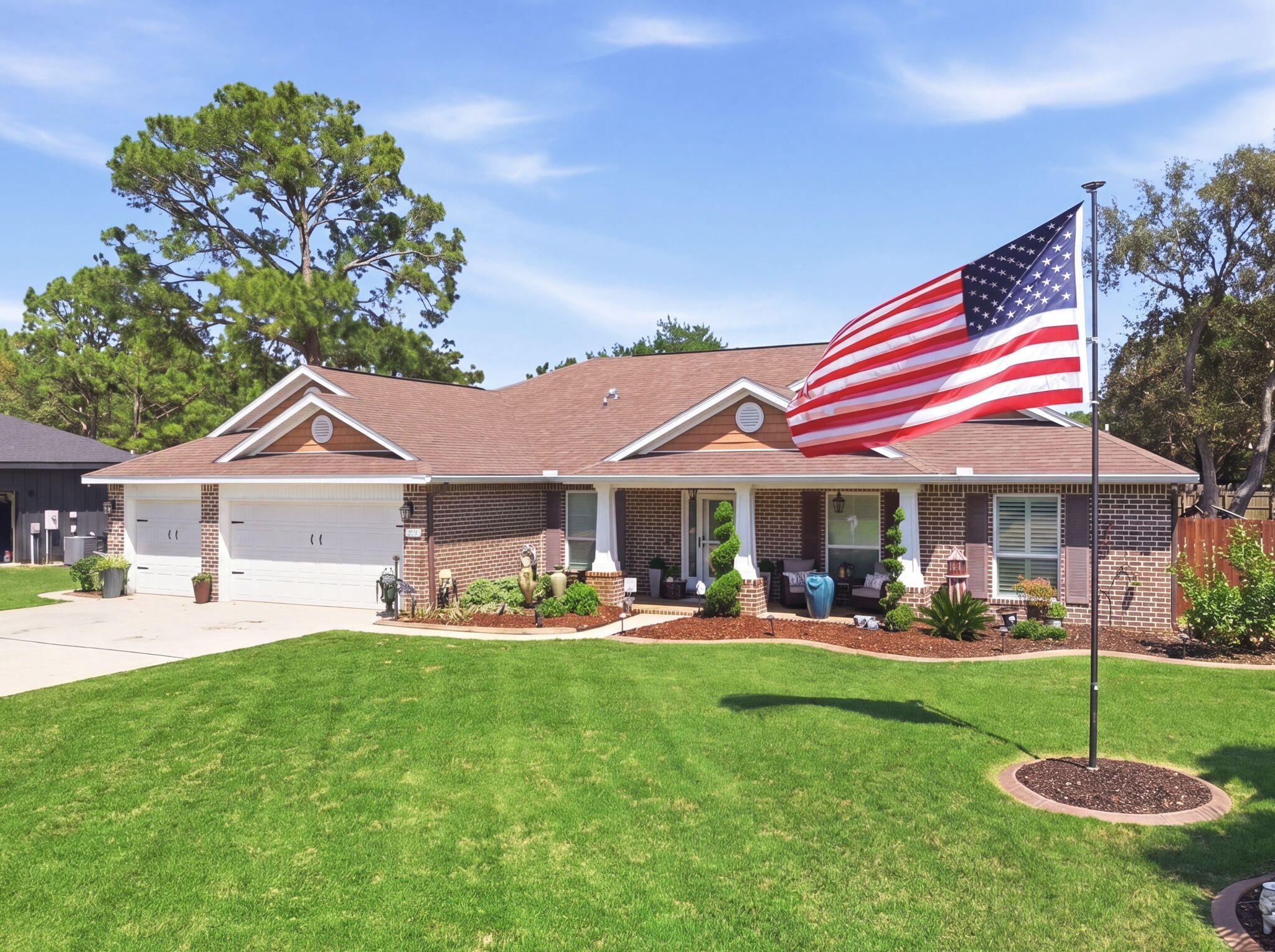 Welcome to this stunning and impeccably upgraded Navarre home. Combining luxury and efficiency with a fully paid-off ground-mounted solar panel system. The interior transitions seamlessly from the formal dining room and the elegant study - enclosed by custom glass French doors - to the main living areas featuring durable wood-look tile and sophisticated plantation shutters. The heart of the home is a chef's dream of a kitchen - showcasing gorgeous crème colored cabinetry with under and above cabinet accent lighting, high-end Samsung appliances, granite countertops, breakfast bar, and a stunning custom-built coffee bar with granite countertops and glass cabinetry. Decorative touches like a shiplap feature wall, new designer chandeliers throughout the home, and a custom-shelved pantry with a glass door elevate the aesthetic. The primary suite serves as a true sanctuary, featuring a tray ceiling with wood beam details, enhanced recessed lighting, custom-built walk-in closet systems, and a spa-like ensuite bathroom with double vanity, walk-in shower, upgraded mirror and light fixtures, water closet with bidet toilet, and a soaking tub. All four bedrooms offer a premium feel with high-end plush carpet and upgraded padding. The guest bathrooms have been fully remodeled - one to include a fully tiled walk-in shower, the other with a jetted tub with heavy glass doors and tiled walls. Practicality meets style in the laundry room with its custom wood shelving and the garage, which features professional floor coating, upgraded lighting, and overhead storage racks. The backyard is an absolute private oasis designed for world-class entertaining. A magnificent 32-foot saltwater pool with a custom rock waterfall and paver fire pit serves as the centerpiece, surrounded by lush Zoysia grass, palm trees, and decorative curbing. Outdoor dining reaches new heights under a 12-foot pergola housing a full kitchen equipped with KitchenAid and Blackstone grills, an ice maker, and a beverage fridge. For year-round comfort, the back lanai has been enclosed to provide an approximate 200 additional square feet of climate-controlled space, supported by both the main HVAC and a solar-powered mini-split. Additional upgrades include stamped concrete flooring on the front porch and lanai, a second large pergola, a storage shed, and a full gutter system. On top of all of this, you get to enjoy all of the amenities that Holley By The Sea has to offer - including a boat ramp, 8 clay tennis courts, a community event hall, 3 different pools, exercise room, and more!