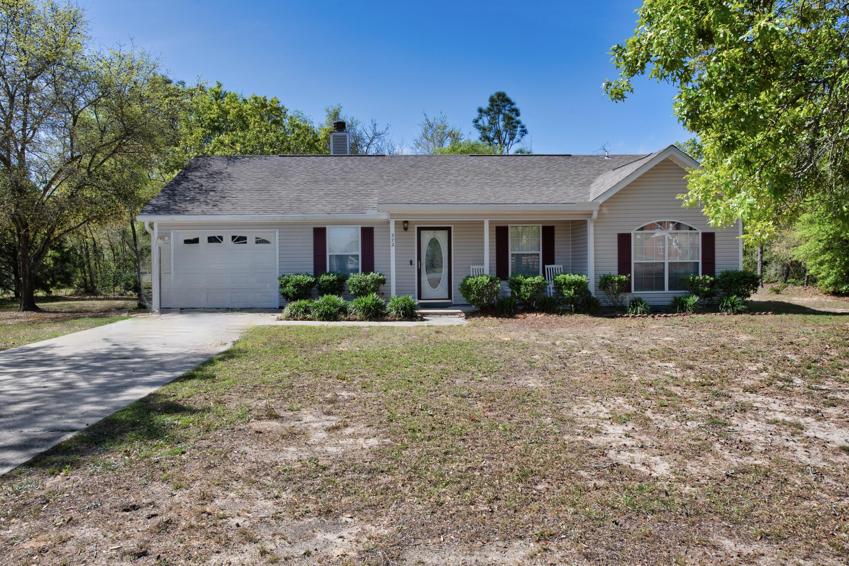 Almost 1 acre with a 3 bedroom, 2 bath, 1 car-garage with NO HOA, this well kept home is ready to move in and call it home. With almost 1300 sq ft of living space, enjoy the living room with a  fireplace, carpet throughout with exceptions to the bathrooms, kitchen/dining & laundry rooms. The kitchen has plenty of cabinets, counter space and a center island.  There are storm doors installed which serves as an additional barrier against rain and wind while also letting in natural light and fresh air when desired. Home is sold unfurnished but some of the furniture is negotiable to purchase. Plenty of space to have a garden to grow your own vegetables. Close enough to enjoy DeFuniak Springs but away from the hustle and bustle of city life. Buyer(s) are responsible to personally verify all details for property and dimensions. Any information contained in this listing is believed to be accurate but is not guaranteed.
