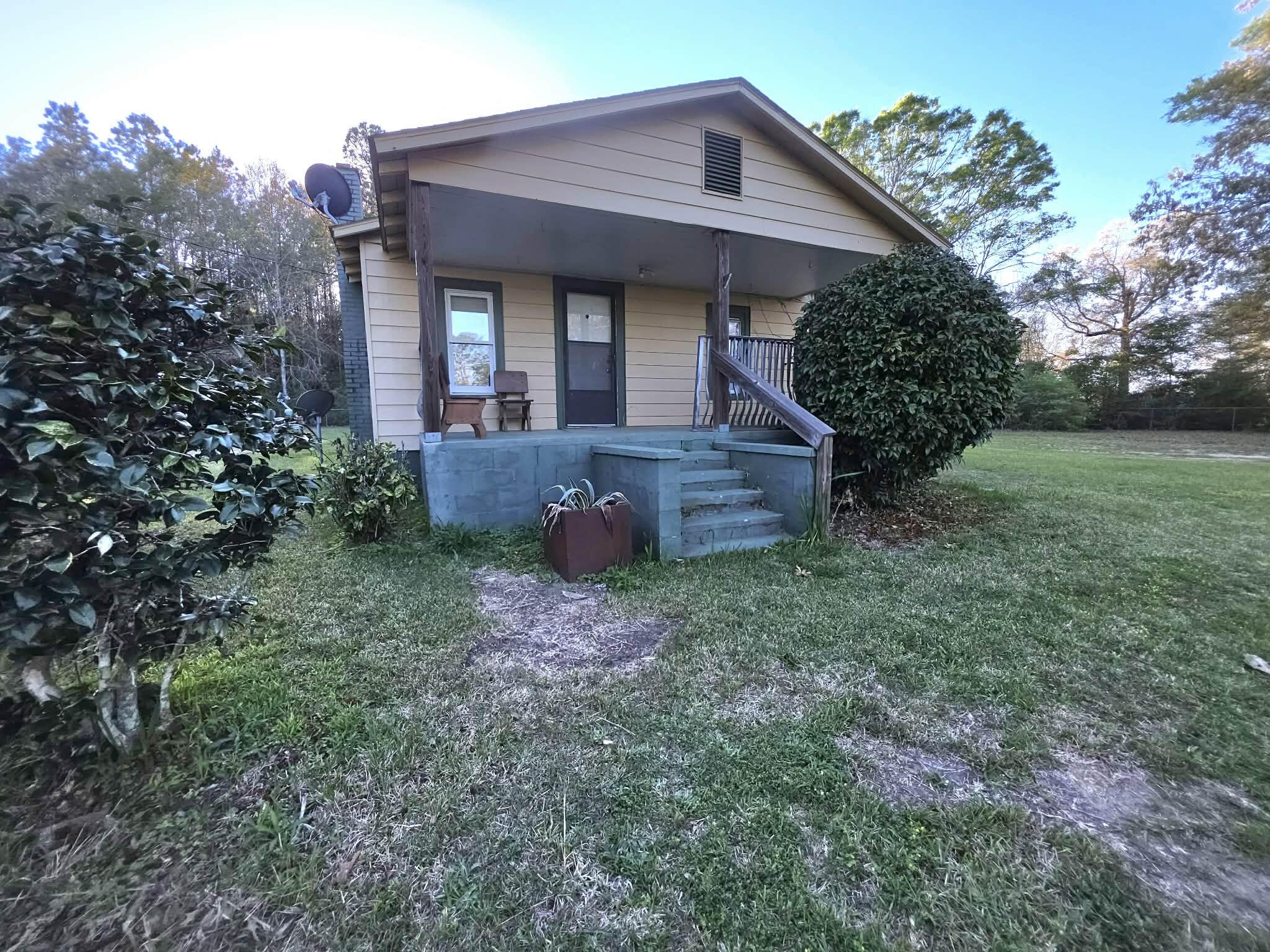 Looking for somewhere out in the country to call home - this 1-acre lot offers a large chain linked fenced yard covered in flowering trees,magnolias, and has a huge area for a large garden and also includes a ton of storage out back. Property includes a well as well as septic, but condition is unknown on both nor guaranteed. Property includes County water and power as well as a 1950s country farmhouse just waiting to be refurbished. The property is amazing and the location allows easy access to Crestview as well as Eglin AFB. Home is sold as is and is not able to finance however don't pass this one up - theendless opportunity is here!