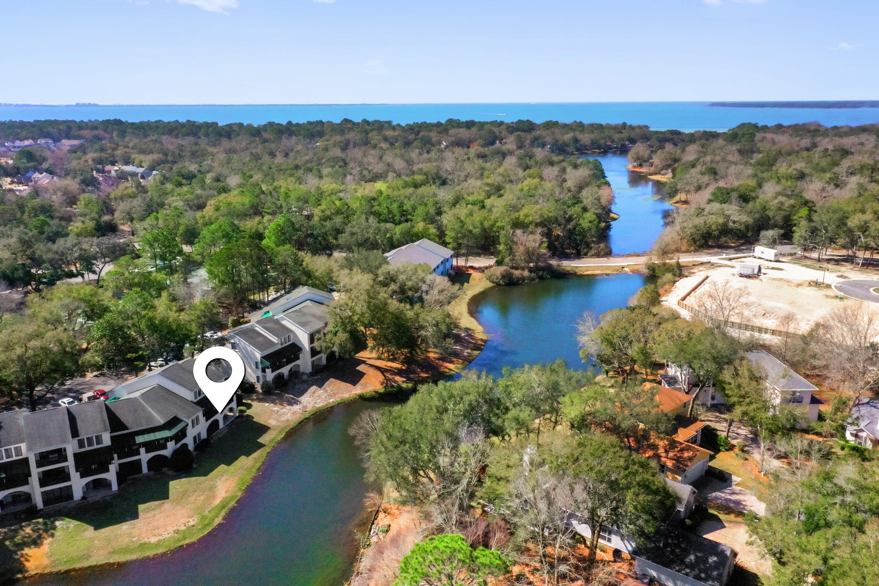 If you've been searching for lakefront living with a true sense of home, this beautifully remodeled downstairs corner unit offers exceptional natural light, added privacy, and an ideal Bluewater Bay location.  Additional windows unique to its corner setting fill the bright, open layout with warmth and inviting charm. From the moment you step inside, you'll feel the welcoming atmosphere that makes this home truly special.  The updated kitchen flows seamlessly into the  spacious living area, and two covered patios provide peaceful lake views.  Renovated in 2020, updates include new cabinetry, Silestone countertops, appliances (including washer and dryer), tile and carpet flooring, and beautifully updated bathrooms.  The Master Bedroom offers a generous walk-in closet with custom built-ins, providing exceptional storage and intentional organization. Bathrooms include thoughtfully designed accessibility features that enhance comfort and everyday ease.  Additional updates to include fresh interior paint in 2023, HVAC replaced in 2018, and Water Heater replaced in 2020. Enjoy a prime location just minutes from the Bluewater Bay Tennis Center, Bluewater Bay Marina, waterfront dining at LJ Schooners, pickle ball, golf, and more.