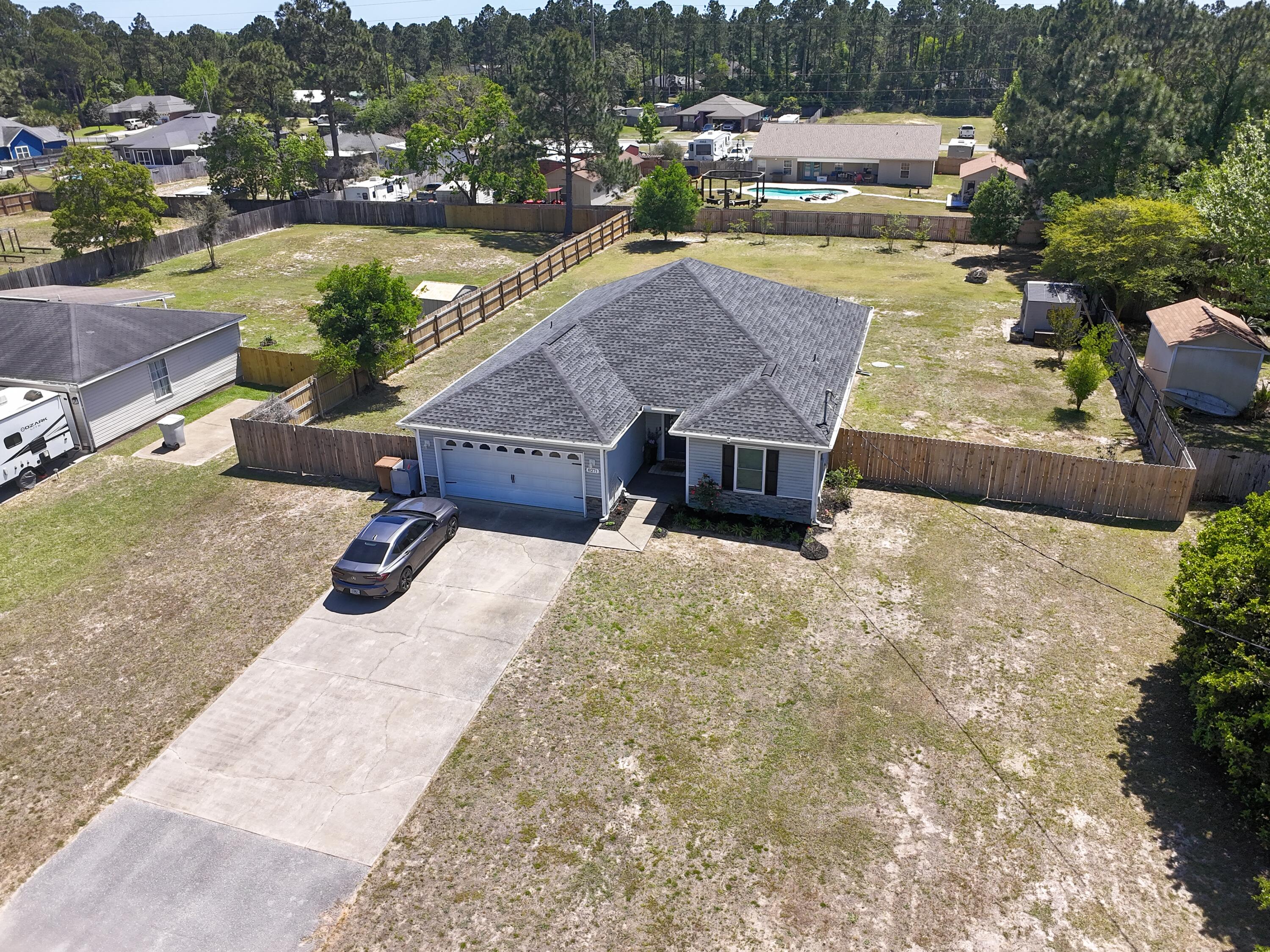 Welcome to your dream oasis in beautiful Navarre! This stunning 3-bedroom, 2-bathroom home effortlessly combines modern elegance with practical features. Step inside and be greeted by luxurious LVP flooring throughout, ensuring a carpet-free living environment that's both stylish and easy to maintain. The heart of the home boasts a spacious kitchen with gleaming granite countertops, perfect for culinary adventures.

Your peace of mind comes first, thanks to state-of-the-art impact windows and active termite pest treatments safeguarding your investment. With no HOA restrictions, enjoy true freedom in customizing your property. Outdoors, discover an inviting 18x35 pavered patio where relaxing evenings await amidst the serene landscaped surroundings maintained by a full sprinkler system and complemented by well-designed gutters. For those plumbing-conscious homeowners, a reliable public sewer connection guarantees hassle-free waste management.
Roof 2020 - HVAC 2019 - Water Heater 2021 
Experience contemporary comfort paired with durability in this move-in-ready gem designed for easy living and entertaining - truly a rare find!