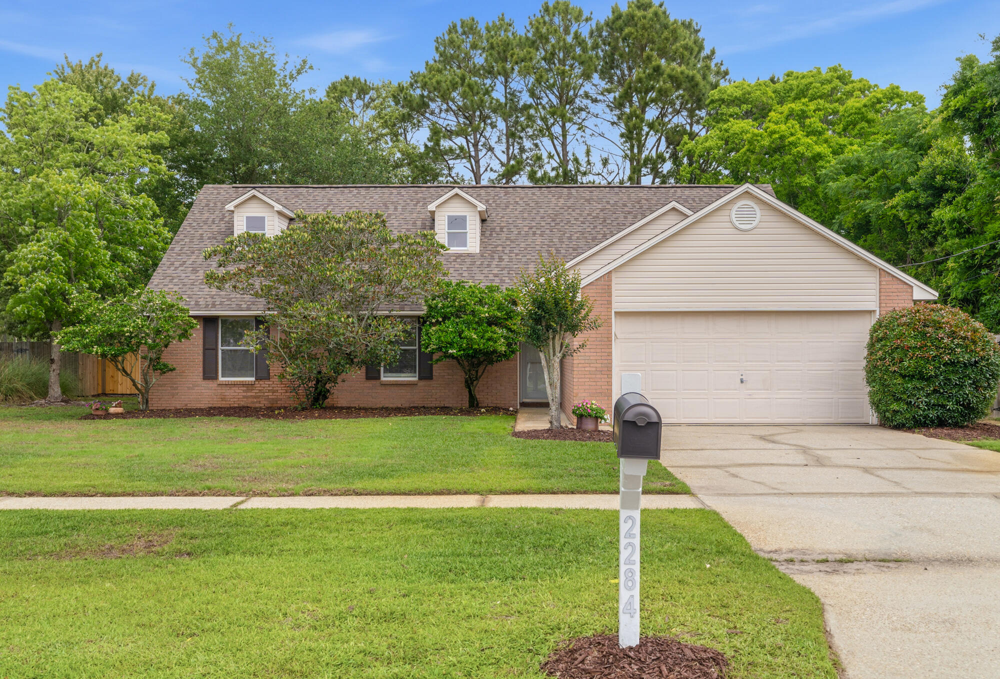 Space, style, and flexibility - this East Navarre home delivers it all. This 4BR/3BA home with a 2-car garage offers a layout designed for real life. The beautiful new and inviting living room flooring directs you across to a beautifully tiled outdoor patio beyond the paneled sliding glass doors.  Great natural lighting and new retractable ceiling fans add elegance and circulation. Upstairs, a spacious loft with LVP flooring, private bedroom, full bath, and 2 storage closets create the perfect setup for guests, a 2nd living area, or multi-gen living. The master suite is conveniently located on the 1st floor. The spacious kitchen has gorgeous granite countertops, and big-ticket updates are already handled for peace of mind, including a newer roof and hurricane impact windows  (2022), HVAC and water heater (2026). Enjoy the freedom of no HOA, and the convenience of being close to stores, restaurants, and best of all - within 5 miles from the beach! Whether you're hosting, relaxing, or working from home, this one checks all the boxes! Schedule a tour and come see for yourself!