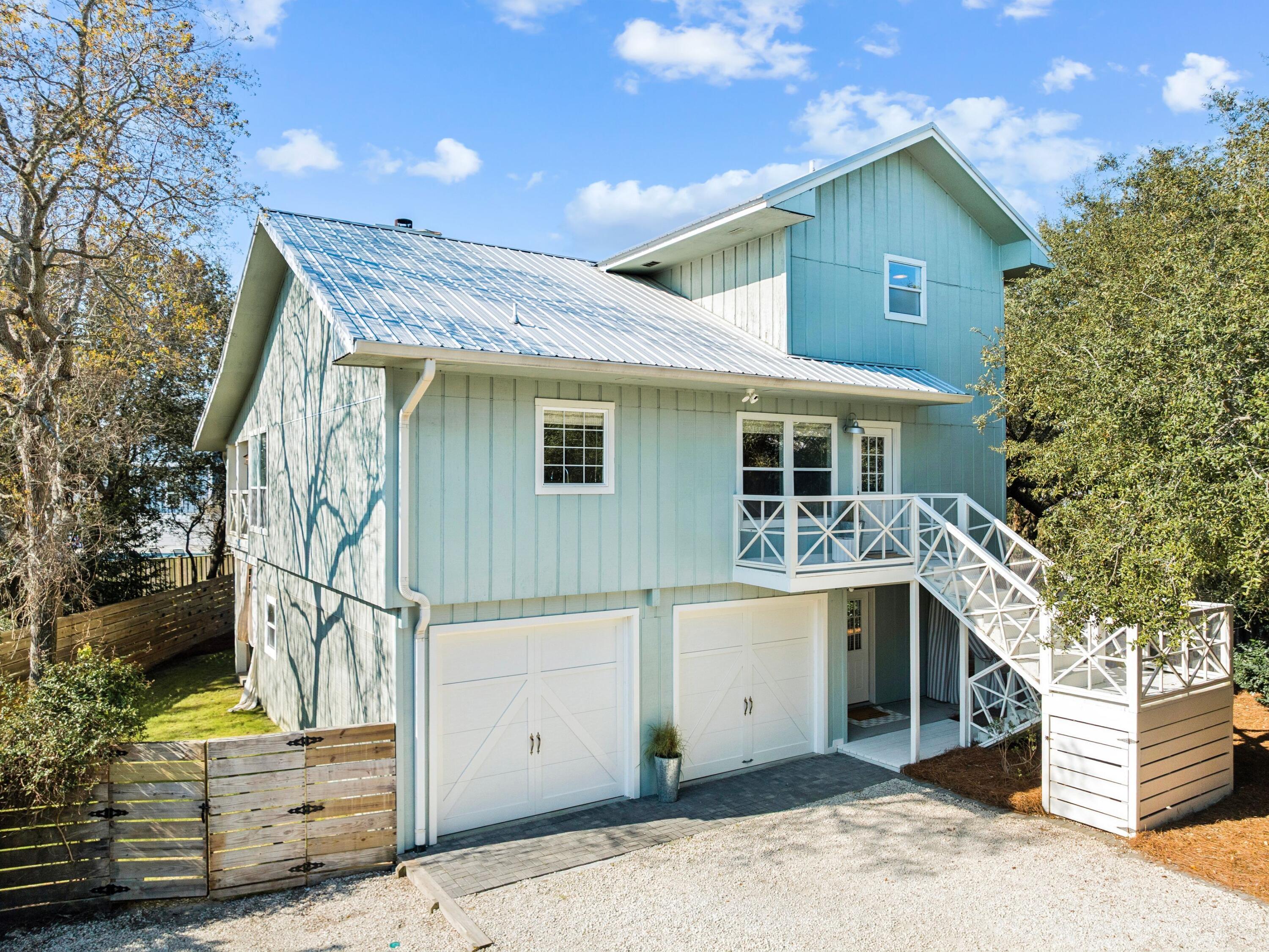Located on a spacious quarter-acre lot in the Beach Highland community of Dune Allen, this 3 bedroom, 3 bath home offers an excellent opportunity for a primary, second home, or vacation rental with just a short stroll to the public beach access across from Stinky's restaurant. The main living areas occupy the second and third levels, featuring an open-concept kitchen and living room with vaulted ceilings and access to a spacious porch overlooking the backyard. The kitchen includes a large island, farmhouse sink, and beadboard cabinetry for a classic coastal feel. The tree-lined backyard provides ample room for a swimming pool to be added. The second level includes a guest bedroom, full bath, and laundry, while the third floor primary suite offers a walk-in closet, en-suite bath, and bonus flex space. The ground level features a separate lock-out apartment which includes a kitchenette, living area, bedroom, bath, and laundry. A perfect, private first floor guest suite. Come enjoy all that Beach Highland has to offer.