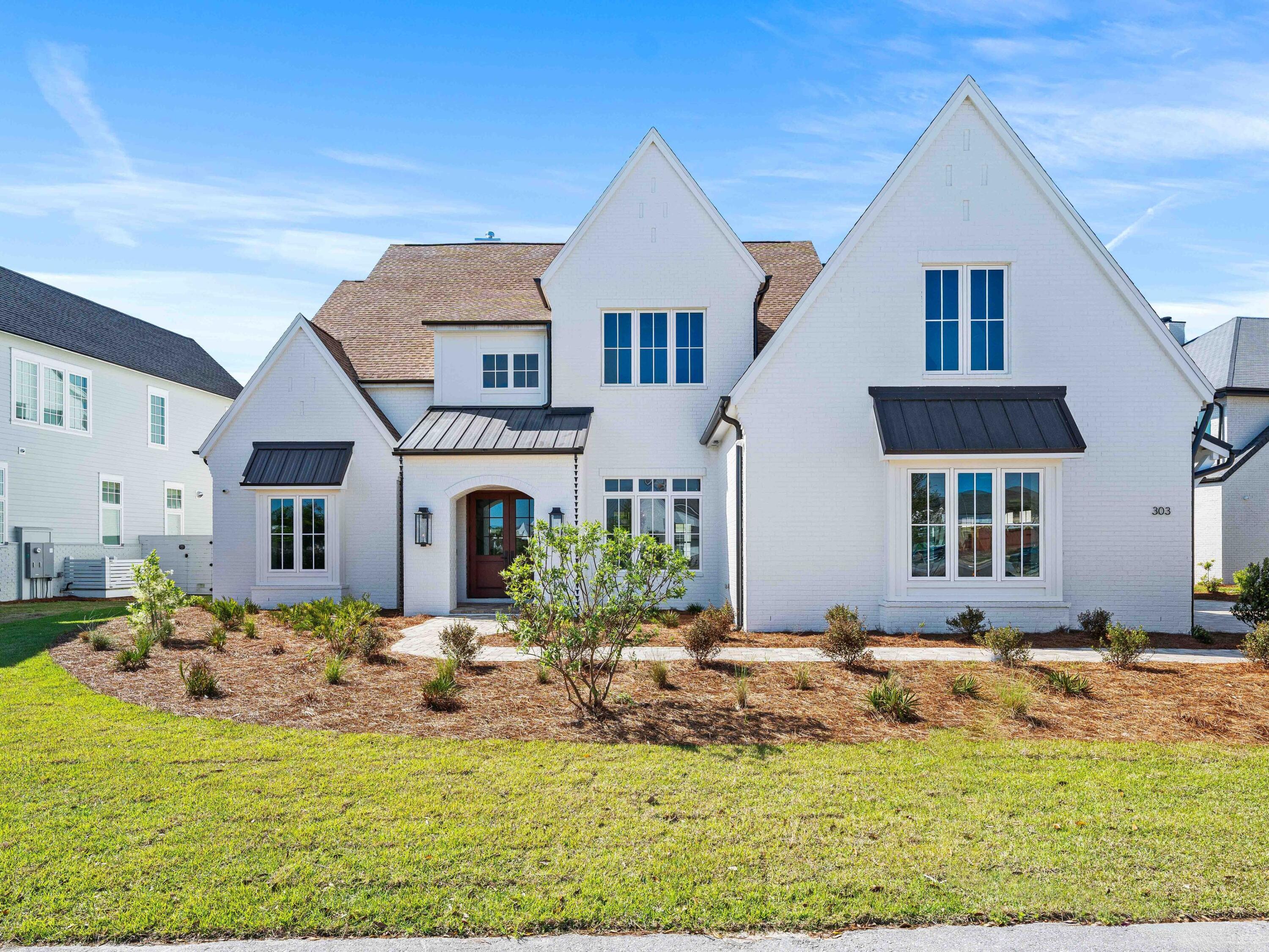 One of fewer than 20 estate-sized homesites exceeding a half-acre in all of Watersound Camp Creek this property is a rarity that is being offered as a completed residence at the highest caliber.
Set on .53 acres at 303 Golfridge Drive, this newly constructed 6,895-square-foot estate is designed around a central courtyard that transforms the oversized homesite into a true compound. A 16-by-30 heated pool plus spa anchors the outdoor living space, flanked by a covered porch with gas fireplace and full summer kitchen. This layout creates an entertainment footprint that simply cannot be replicated on the average smaller sized lots.
The main residence offers five bedrooms, five full baths, and two powder rooms across two stories. A vaulted entry and grand staircase set the tone.  Venetian plaster walls and ceilings, coffered and wallpapered ceiling details, quartzite countertops, and curated designer fixtures carry through every room. The kitchen is a chefs dream  with cooktop, oven, a Subzero refrigerator, and double dishwashers that support both daily living and large-scale entertaining.
A detached casita elevates this property beyond a conventional single-family home. A spacious living room, 10-foot glass sliders overlooking the pool, kitchenette, laundry, powder bath, and a full guest bedroom with ensuite bath, the casita functions as a self-contained guest house.  It is the perfect spot for extended family, visiting friends, or a private home office removed from the main residence.
The second floor includes a media and game room with breakfast bar, beverage refrigerator, and three additional guest bedrooms with ensuite baths. A 400-square-foot flex room above the three-car garage includes a half bath, laundry, and kitchenette and offers yet another layer of versatility. Another 650 square feet of conditioned storage is in addition to the living area square footage.
With only 264 homes planned at full buildout and fewer than 15 developer lots remaining, estate-scale opportunities in Watersound Camp Creek are finite. Ownership conveys with an exclusive Watersound Club membership allowing access to three golf courses including the Tom Fazio-designed Camp Creek course and the new Davis Love III-designed The Third course, the gulf-front Beach Club with complimentary chair and umbrella service, an 11,000-square-foot wellness center, resort pools, and multiple private dining venues.