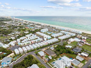 The sellers of this gorgeous like new home beach home have taken out the guesswork for what they are willing to accept and priced to sell! This opportunity will not last long. This price provides instant equity for any buyer. Situated in the heart of Margaritaville Beach Cottage Resort, this thoughtfully designed beach cottage delivers a carefree, resort-style lifestyle paired with exceptional short-term rental potential. Just steps from the community's vibrant centerpiece, The Club, owners and guests enjoy access to a resort-caliber amenity set, including an expansive oasis-style pool, towering waterslide, lazy river, and poolside bar and grill with full-service dining. A short stroll leads to 580 feet of dedicated sugar-white sand beach, where chair and umbrella service, beachside dining and the emerald waters of the Gulf. Onsite amenities included the License to Chill Restaurant, a state-of-the-art fitness center, and a family-friendly arcade. Inside, the cottage's open-concept floor plan is designed for gathering, with abundant natural light and coastal-inspired interiors that evoke a bright, playful beach aesthetic. The gourmet kitchen features a striking oversized quartz island, ideal for entertaining. The main-level primary suite opens directly to a private six-person hot tub, offering a peaceful retreat after a day at the beach. Thoughtfully furnished and turn-key!
