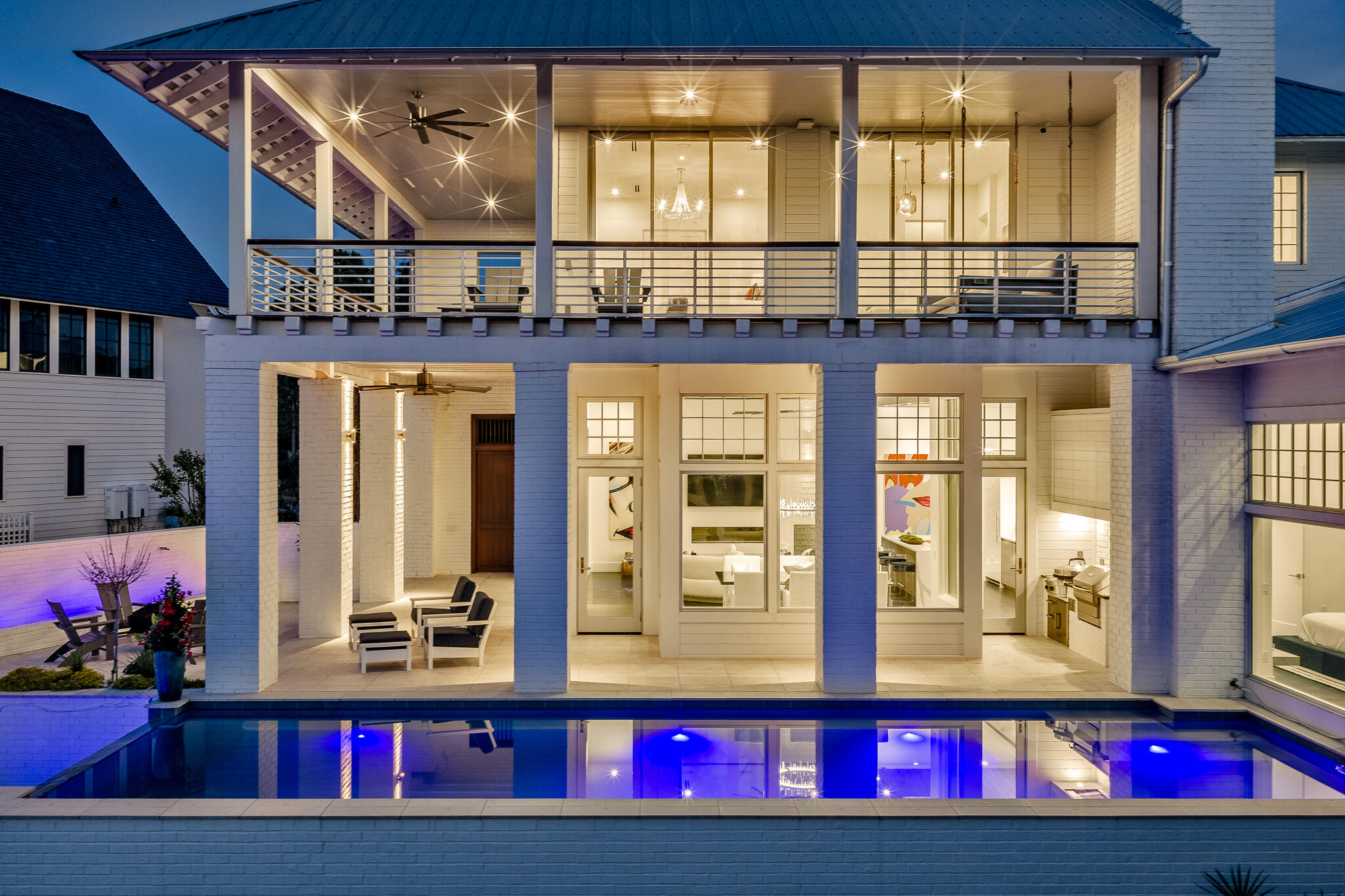 Located in the prestigious gated waterfront community of Churchill Oaks, this amazing contemporary home offers 4 bedrooms and 4.5 bathrooms plus a custom bunk room.  Positioned to capture the expansive bay views and backing to a conservation preserve, the property provides exceptional privacy.  Features include two primary suites, three laundry rooms, ceramic tile flooring, a walk-in climate controlled wine room and a steam shower.  The chef's kitchen is equipped with premium Miele appliances, custom cabinetry and designer lighting.  Outdoor living includes a negative edge pool and fire pit, ideal for enjoying the waterfront setting.  The property also includes a 50 FOOT BOAT SLIP making it ideal for boating enthusiasts. A beautifully designed carriage house above the garage, is complete with a private entrance for added flexibility and privacy.  Connected to the main residence by a charming breezeway, the space is ideal for guests and extended family. The carriage house features a mini kitchen, and it's own washer and dryer, creating a functional and comfortable separate living area.  Churchill Oaks includes an expansive bayfront clubhouse, marina and walking paths.