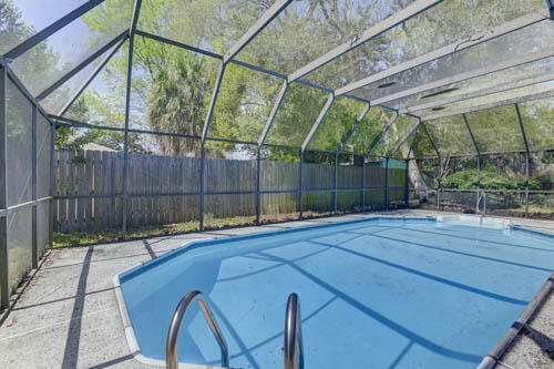 OPEN HOUSE SATURDAY MARCH 28 11-2. Electric updated!! Stunning 3-bedroom, 2.5-bath mid-century modern ranch in the highly sought-after Kenwood neighborhood of Fort Walton Beach. This sprawling single-level home blends timeless architecture and has newly updated electrical. Expansive windows invite natural light and showcase the property's beautiful mature oak trees. Enjoy a private backyard retreat with a heated pool and screened lanai, perfect for relaxing or entertaining. Located in a golf cart-friendly community with access to golf, tennis, and pickleball, and just minutes to Eglin AFB, Hurlburt Field, and the white-sand beaches of the Emerald Coast. Home has a full-home gas generator, hurricane shutters and newer roof.