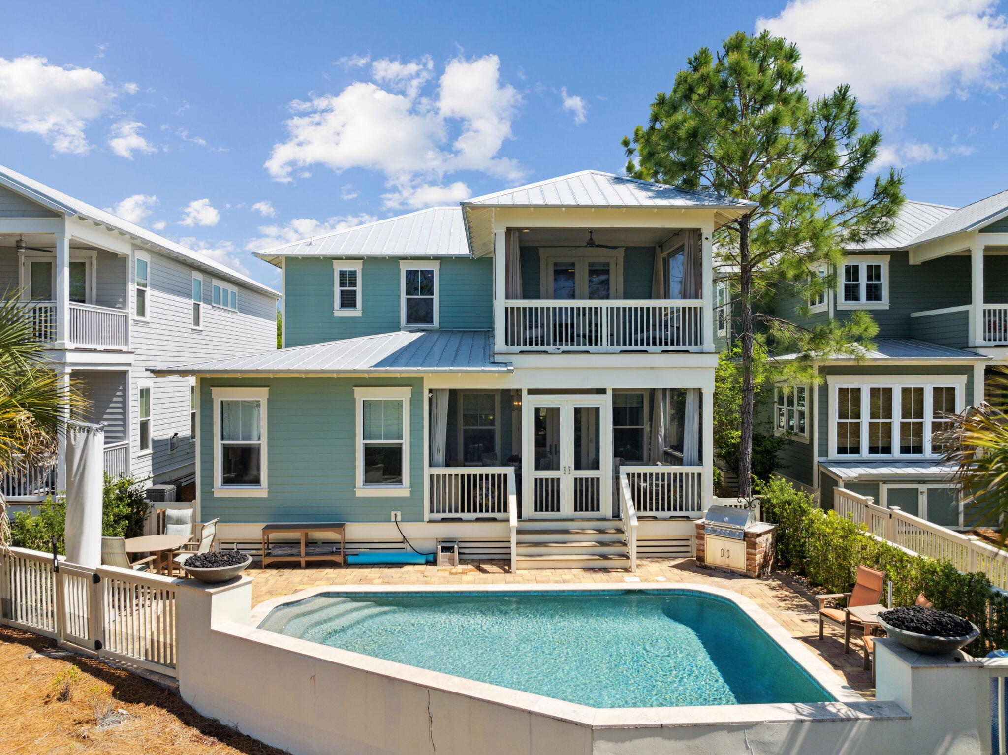 An Entertainer's Paradise in NatureWalk at Seagrove.  

Welcome to your coastal retreat, perfectly nestled against a tranquil, wooded preserve in the coveted NatureWalk at Seagrove community. This luxurious home would make an incredible primary home, second home, or investment property.  

Outdoors, your private oasis awaits: a heated saltwater pool with a cascading water feature and dramatic fire bowls sets the stage for unforgettable gatherings. The screened-in back porch features a full summer kitchen with granite counters, a fridge, and built-in grill--ideal for entertaining or relaxing poolside in total privacy.
