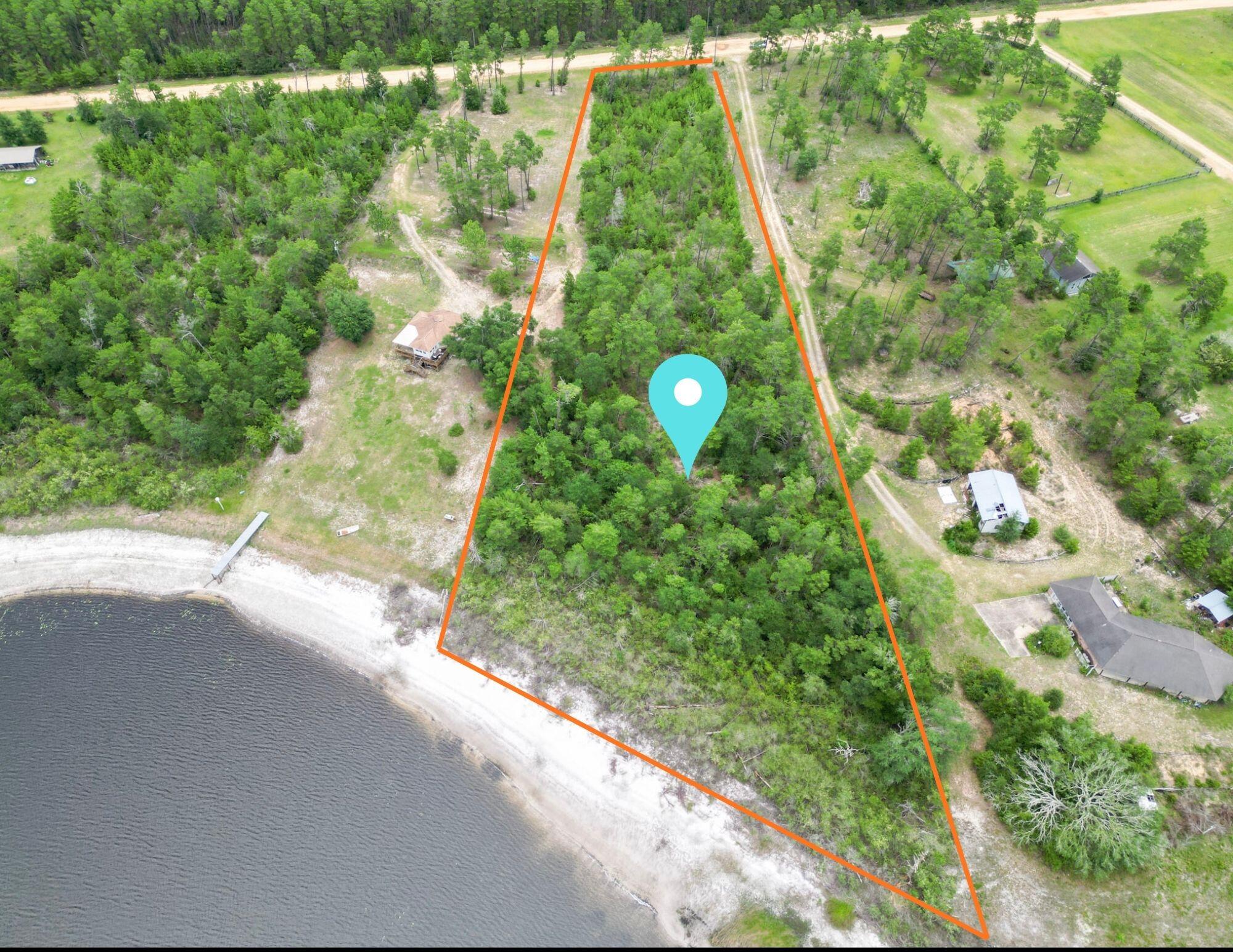 Escape to a quiet and peaceful retreat in the gated community of Long Lake Estates. This is a rare opportunity to own premium lakefront acreage in one of the area's most scenic and private settings. Lot 12 offers 5.26 acres with approximately 283 feet of frontage on beautiful Long Lake, providing the perfect backdrop for your dream home, weekend getaway, or future investment. Enjoy the freedom to build at your own pace with no build-out time requirements and minimal building restrictions. Whether you envision a custom lakefront estate, cozy second home, or private retreat, this property offers endless possibilities. Long Lake is exclusive to the community and known for its clear, refreshing waters. Spend your days swimming, boating, fishing, kayaking, paddleboarding, or simply relaxing by the lake from the privacy of your own backyard. The natural beauty, abundant wildlife, and peaceful surroundings create an unmatched lakeside lifestyle. Conveniently located just 35 minutes north of Panama City Beach in the peaceful Greenhead area, this property offers easy access from Highway 77 and is situated near the community's gated entrance. Combining privacy, recreation, and convenience, this exceptional lakefront homesite is a rare find. Don't miss your chance to own a slice of Florida lakeside paradise.