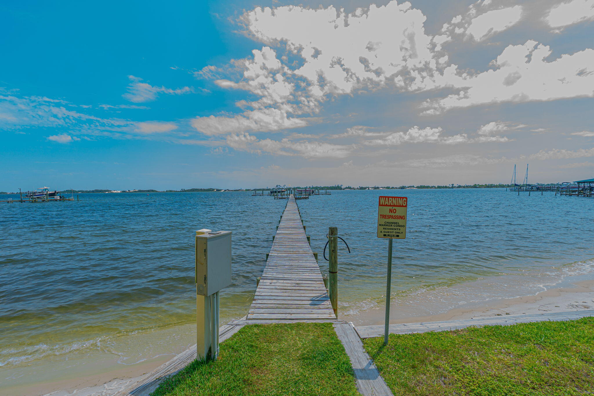 Incredible Price Improvement! Take a look at this waterfront condo.  This 3 bedroom, 2 bath, first floor condo might be the one for you! You'll have water views from your living room, kitchen and primary bedroom. The two guest bedrooms are perfect for the friends and family you will surely be hosting! The attractive, neutral-toned tile is throughout the home. For an additional fee, there are boat slips available for owners, via first come, first serve waiting list. There is permanently affixed storm protection for the water facing sliding glass doors.