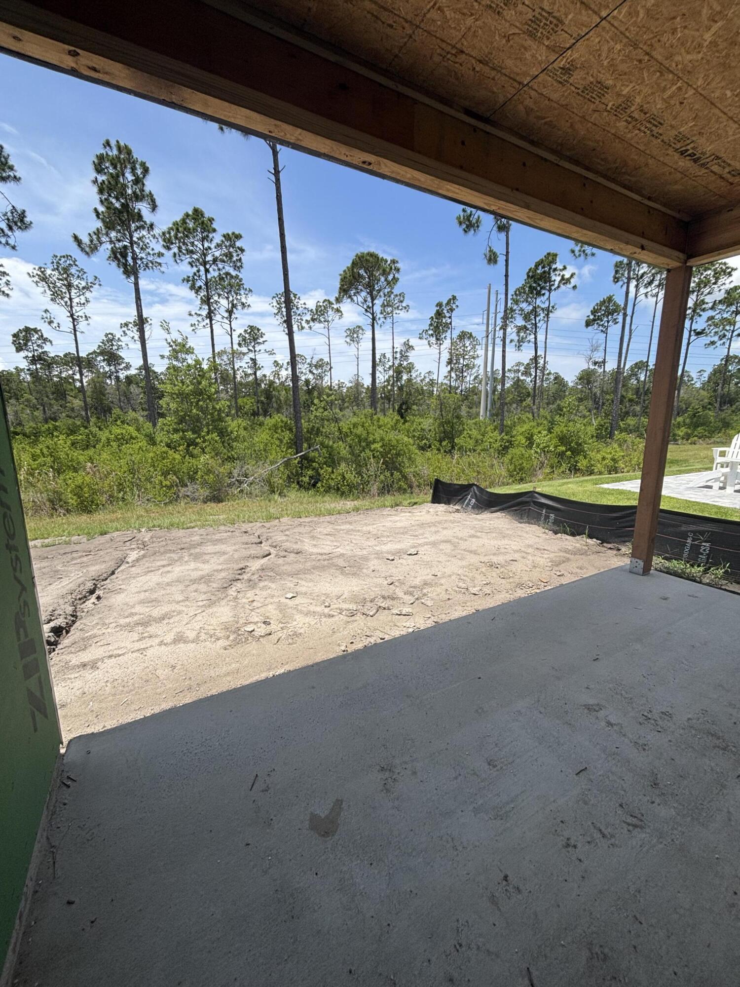 The Lucas plan offers 1,418 square feet, 2 bedrooms, 2 bathrooms, and a 1.5-car garage in the Villas at Longleaf Park within the Watersound Origins community. Positioned on a wooded homesite, the property combines low-maintenance living with functional outdoor space, including a covered rear patio measuring 15'8' x 8'. Estimated completion is Oct/Nov '26.

Designed with an open layout, the kitchen, dining, and family room connect beneath 10-foot ceilings with 8-foot interior doors throughout. Large windows and direct patio access bring natural light into the main living areas while maintaining a practical indoor-outdoor flow.

The kitchen includes upgraded soft-close cabinetry, Level 2 quartz countertops, an upgraded backsplash, walk-in pantry, and an upgraded GE appliance package with built-in appliances, a 5-burner gas cooktop, and upgraded hood. Luxury vinyl plank flooring extends throughout the home, complemented by craftsman-style trim and impact-rated windows.

The owner's suite includes a spacious walk-in closet with direct access through the bath to the laundry room, creating a functional connection to the garage entry and kitchen area. The bath features level 2 quartz countertops, while the guest bath includes an upgraded ceramic tile surround.

Additional features include a tankless water heater, gas grill rough-in, Smart Home package, irrigation system, and lawn maintenance included for simplified ownership. Each residence is separated by a structurally independent 2-hour fire separation wall with insulated framing and layered gypsum board construction for added privacy and sound separation.

Located within Longleaf Park at Watersound Origins, the Villas offer convenient access to Watersound Town Center, Publix, dining, medical offices, Hwy 98, Village Commons, trails, and the Origins Golf Course.