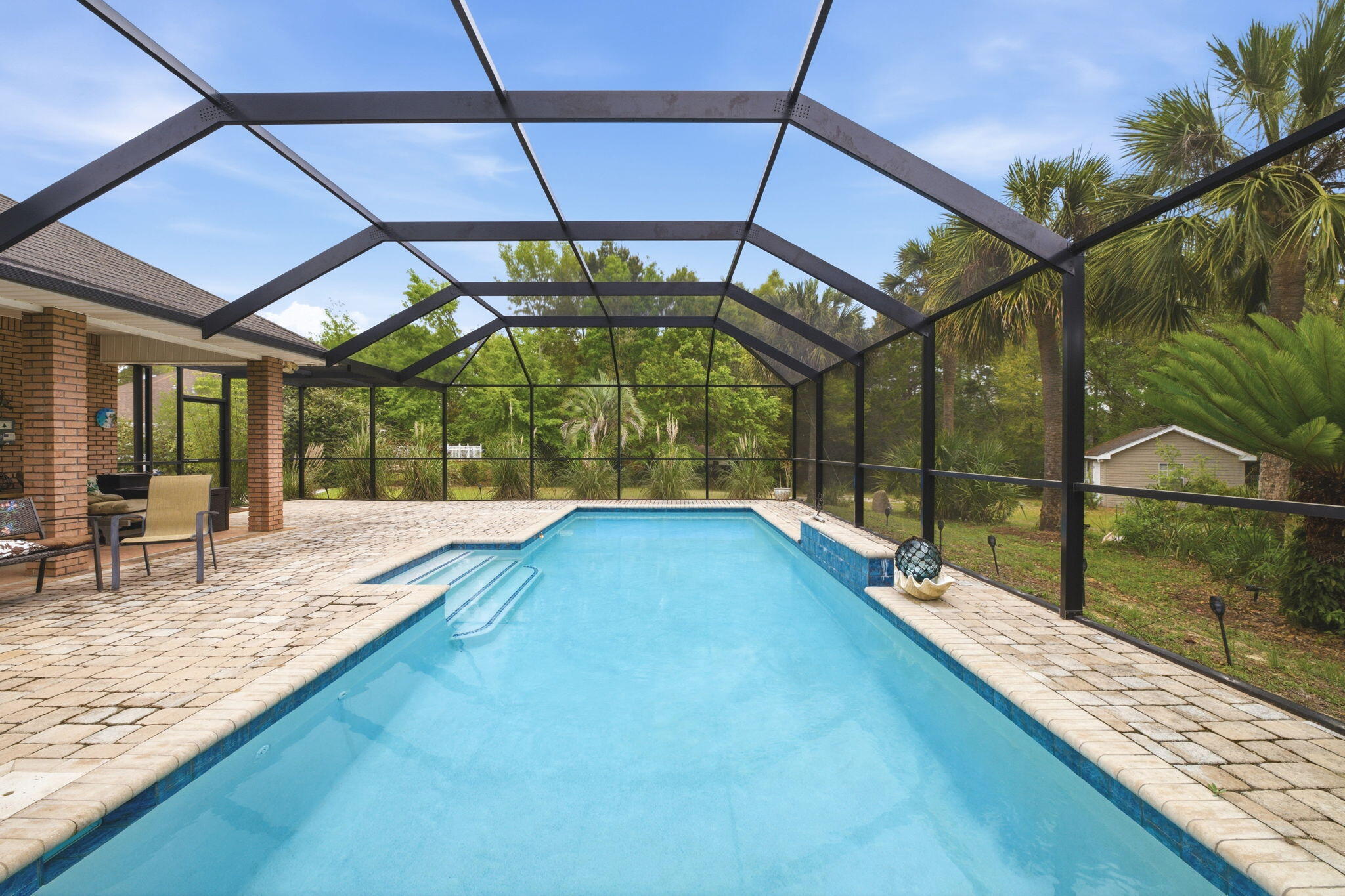 *NEW ATTRACTIVE PRICE ADJUSTMENT AND A NEW ROOF AT CLOSING WITH ACCEPTABLE OFFER* 

NEW PHOTOS UPLOADED 5/23 DUE TO NEW VACANCY!! 

Tucked away on a rare 0.61-acre homesite at the end of a private cul-de-sac, this property offers the kind of space, privacy, and peaceful surroundings that are becoming harder to find. Backed by wooded natural scenery, the setting feels quiet and secluded while still being conveniently located.

The extended resurfaced driveway provides plenty of room for multiple vehicles, guests, or recreational toys, and the oversized side-entry garage adds even more storage and functionality. Inside, the home features three spacious bedrooms plus a large bonus room currently used as a bright art studio. With abundant natural light and beautiful views overlooking the pool, this flexible space could easily serve as a home office, den, playroom, or creative studio depending on your needs. 
The home has been thoughtfully remodeled to create a more open connection between the kitchen and living area, allowing the main living space to feel bright, inviting, and ideal for entertaining. All kitchen appliances convey with the sale, making the home move-in ready.

Step outside to enjoy your private backyard retreat featuring a heated pool, new enclosure, and additional paver space--perfect for relaxing, entertaining, or enjoying Florida's beautiful weather year-round.

Additional highlights include:

" Solar panels that will be fully paid off at closing - a valuable bonus for future energy savings

" A storage shed that conveys as-is

" A large laundry room with plenty of space to add cabinets, folding counters, or even a work station

" A formal dining room located just off the foyer for gatherings and special occasions

Homes with this unique floor plan and oversized lot rarely come available in this area. Being located on a dead-end road with no cut-through traffic means the cul-de-sac is shared only among neighbors, creating a peaceful environment.

All of this with a low HOA fee of just $595.50 annually, and convenient access to the beach, golf course, and nearby amenities.

The sellers are also offering flexible closing options, whether you need to move quickly or prefer a later closing timeline. If you've been searching for space, privacy, and a truly unique property, this home is one you won't want to miss.

If you're a buyer reading this, please ask your agent for all of the documents in the MLS prior to your visit. Helpful information is there