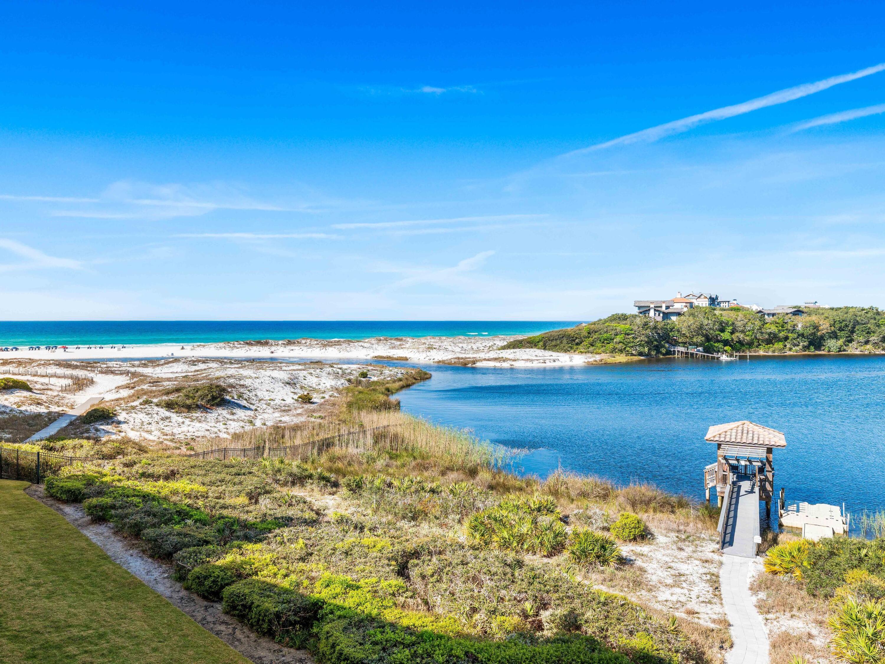 Introducing an exceptional residence that offers breathtaking views of both the Gulf and Lake, where refined luxury meets the rare beauty of a coastal dune lake. Situated within the exclusive gated community of Sanctuary by the Sea, this nearly 4,000-square-foot, single-level property provides sweeping, unobstructed views of the Gulf and Big Redfish Lake from one of the most coveted vantage points along 30A.
Upon arrival, the experience is unforgettable.The sense of arrival unfolds upon entry, where beautifully curated interiors and architectural details create a sense of effortless flow. Expansive living spaces are framed by floor-to-ceiling views and enhanced by ten-foot ceilings, sophisticated finishes, and a calming coastal palette. Recent refreshing includes new carpeting in bedrooms, cabinet updates and furnishing enhancements. 
At the heart of the residence, the spacious living room with fireplace seamlessly opens to an oversized private terrace complete with remote screens--an outdoor sanctuary designed for dining, entertaining, and enjoying the colors of the Gulf sunsets. This is indoor-outdoor living at its finest.

The chef's kitchen is both functional and striking, appointed with Viking appliances, dual islands, and ample cabinetry. A wet bar and a separate dining area help make entertaining easy.

Designed for comfort and privacy, this home features four distinct sleeping spaces and three ensuite baths. One of the rooms includes custom-built bunks plus a second living/media space. The primary suite is spacious and includes multiple sitting areas and private access to the waterfront porch. A spa-inspired bathroom with soaking tub and large shower evokes a sense of relaxation and escape.

With its coveted southwest orientation, this residence is perfectly positioned to capture some of the most breathtaking sunset views along the Emerald Coast. Offered furnished and impeccably styled, it is ready to be enjoyed immediately as a primary or vacation home.

Sanctuary by the Sea is located on 23 pristine Gulf-front acres between the Gulf and Big Redfish Lake--one of the most rare and protected coastal dune lake environments in the world. Residents have access to a range of amenities, including multiple pools, private beach access, a fitness center, a golf simulator, and more. These amenities are conveniently located within walking distance of 30A and the shops and restaurants of Grayton Beach, Watercolor, and Seaside. Don't miss this special opportunity!