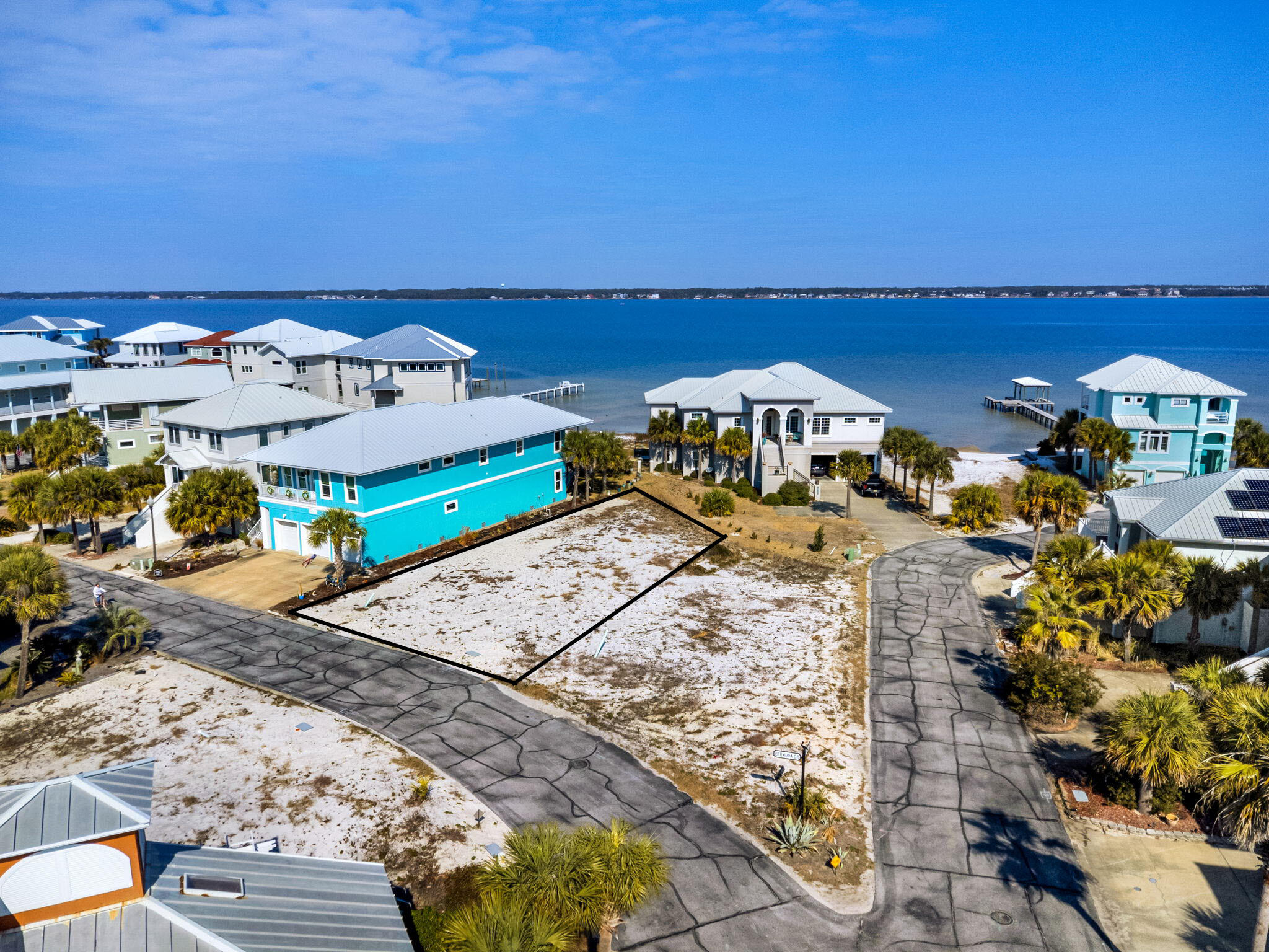 Discover an exceptional opportunity to own a premier homesite in Caribbean Isle, one of Navarre's most sought-after gated communities. This beautiful lot provides the ideal setting to design and build your custom residence, perfectly positioned to capture views of the tranquil Santa Rosa Sound.
Imagine starting each day with peaceful water views and ending it with breathtaking Florida sunsets painting the sky over the Sound, a stunning natural backdrop for your future home.

Residents of Caribbean Isle enjoy the privacy and security of a gated entrance with controlled access, along with amenities designed for both relaxation and recreation. Community features include tennis courts, pickleball courts, and a sparkling community pool, perfect for unwinding after a day at the beach or enjoying time on the water.

Whether you envision a primary residence, a vacation getaway, or an investment opportunity, this homesite offers a rare and desirable canvas to bring your vision to life. Don't miss your chance to own a piece of Navarre paradise, complete with sound views, gated living, and outstanding community amenities.