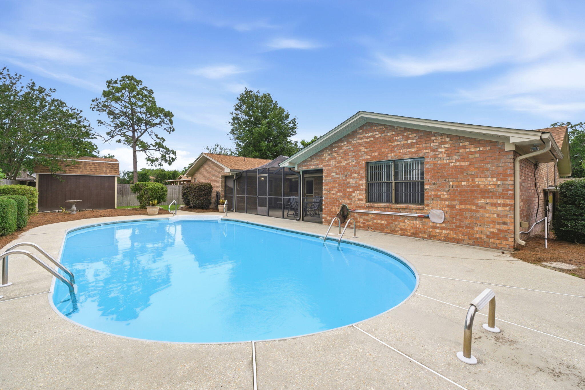 From the moment you arrive, you'll appreciate the care and pride of ownership reflected throughout this well-maintained pool home. Mature landscaping, refreshed planting beds, and inviting curb appeal create a welcoming first impression before you even step inside.

Inside, warm wood beams, a striking brick accent wall, and custom built-ins create character and charm that are difficult to find in today's homes. The spacious bedrooms offer room to spread out, while the thoughtful floor plan provides flexibility for a variety of lifestyles. An oversized laundry room and a kitchen featuring two ovens add to the home's functionality for both everyday living and entertaining.

Perhaps the home's most unique feature is the converted garage space, complete with extensive cabinetry, a sink, refrigerator, microwave area, and two built-in workstations. Whether you envision a home office, hobby space, study area, craft room, game room, or simply incredible storage, this versatile area offers endless possibilities.

Step outside to your own private backyard retreat featuring a screened patio, in-ground pool, privacy fencing, and a storage building perfect for lawn equipment, pool supplies, and additional storage. Whether hosting family and friends or simply enjoying a quiet evening at home, this outdoor space is designed to be enjoyed year-round. From the moment you arrive, you'll appreciate the care and pride of ownership reflected throughout this well-maintained pool home. Mature landscaping, refreshed planting beds, and inviting curb appeal create a welcoming first impression before you even step inside.

Inside, warm wood beams, a striking brick accent wall, and custom built-ins create character and charm that are difficult to find in today's homes. The spacious bedrooms offer room to spread out, while the thoughtful floor plan provides flexibility for a variety of lifestyles. An oversized laundry room and a kitchen featuring two ovens add to the home's functionality for both everyday living and entertaining.

Perhaps the home's most unique feature is the converted garage space, complete with extensive cabinetry, a sink, refrigerator, microwave area, and two built-in workstations. Whether you envision a home office, hobby space, study area, craft room, game room, or simply incredible storage, this versatile area offers endless possibilities.

Step outside to your own private backyard retreat featuring a screened patio, in-ground pool, privacy fencing, and a storage building perfect for lawn equipment, pool supplies, and additional storage. Whether hosting family and friends or simply enjoying a quiet evening at home, this outdoor space is designed to be enjoyed year-round.

Recent updates provide peace of mind, including a roof replaced in 2022, both HVAC systems replaced in 2021, water heater replaced in 2026, new carpet installed 2026 and fresh interior paint throughout. If you're looking for a home with character, functionality, and flexible spaces that adapt to today's lifestyles, this one is a must-see.