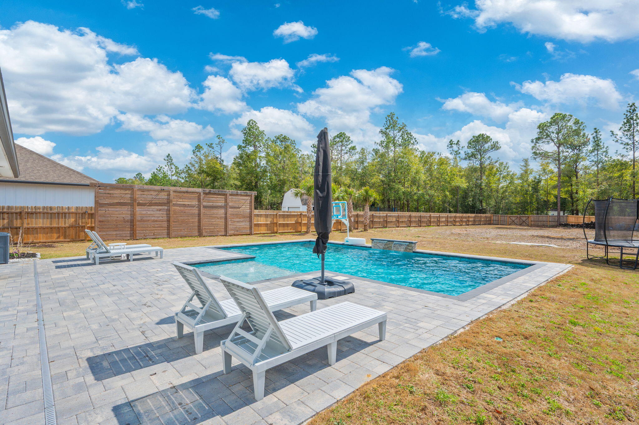 **GORGEOUS - stunning pool home on a 1/2 acre cleared lot in north Crestview, just 5 minutes from Publix, restaurants, and other area amenities. STACKED with updates and turn-key. Saltwater gunite pool has a pebblesheen (lifetime) finish and is 16'x30' and packed with upgrades and has a removable baby gate/fence. This 4 bedroom home features 3 FULL baths and raised ceilings throughout this open floor plan. Beautiful open kitchen overlooks the spacious main living area, and has a large dining area attached. Carpet ONLY in bedrooms with luxury vinyl throughout elsewhere. Fourth bedroom is split from the additional two bedrooms and master bedroom with the third bathroom right outside the room- perfect for guests, in laws, or a private office space. Matching granite countertops throughout kitchen and baths. Crown molding in main living space and master bedroom. Master bath houses double vanities, soaking tub, walk in shower, and custom master closet. Interior of home has also been recently freshly painted! This home was made for Florida living with all the updates to the exterior, providing both a functional and comfortable space for living and entertaining. Front porch, back porch, and THREE car garage all have epoxy floors. Roomy back porch is screened in and leads to your outdoor oasis. The gunite pool has a removable fence surround (easy removal and install!) and paver surround which also leads to an outdoor shower and pathway. The half acre lot has been completely cleared and allows plenty of opportunity for a workshop, shed, or additional outdoor usage. Additional notable exterior features include Govee LED light system, storm door, whole house gutter surround, and solar lights on the fence surround. ADT alarm system with all the add ons. Full upgrades list with additional details available. Schedule your showing today! VA assumable loan. More details available upon request.