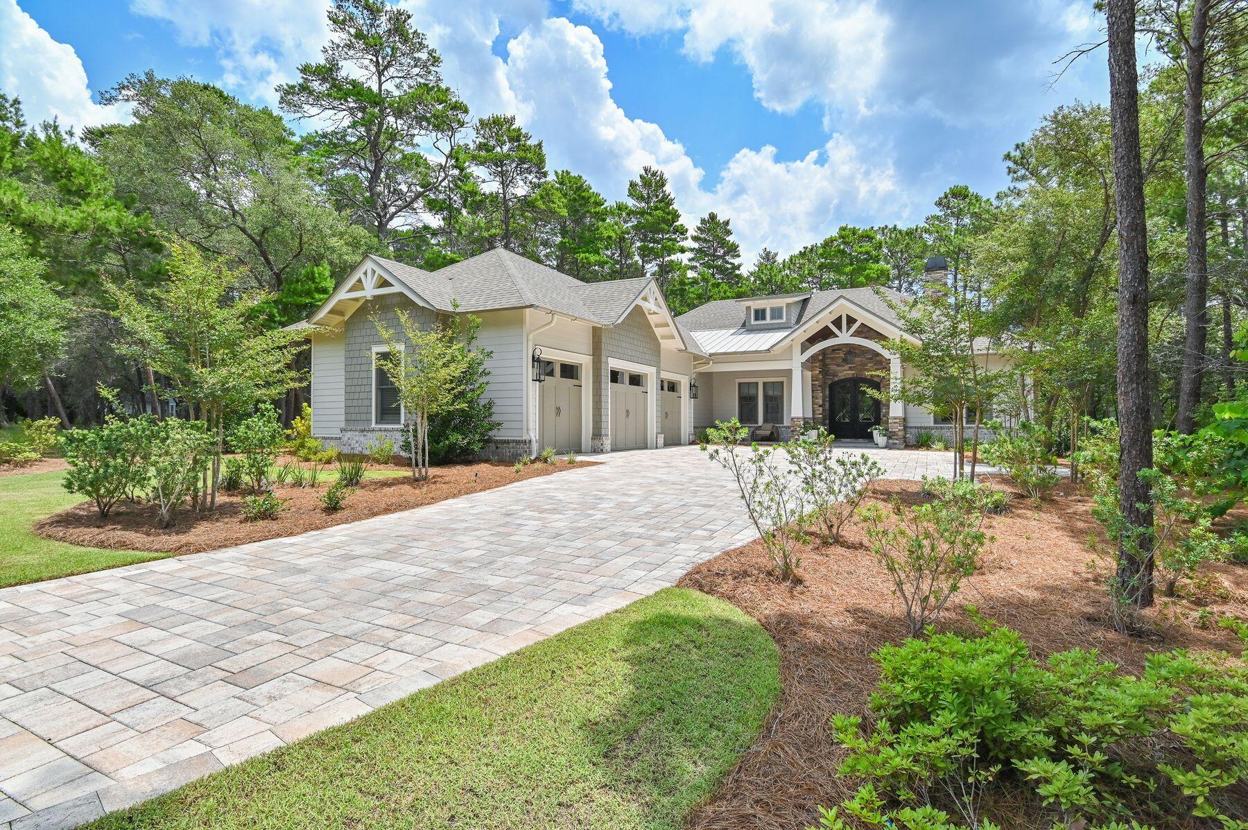 Perfectly positioned on nearly one-half acre overlooking the 10th fairway of Shark's Tooth Golf Course, this custom residence, built in 2023 by a notable custom builder and architect, offers 2,937 square feet of beautifully appointed one-level living in the gated community of Wild Heron. 

Located on one of the community's most desirable streets, this 4-bedroom, 3.5-bath home enjoys peaceful golf course views, a fenced backyard with plenty of room to add a pool, quality 2x6 construction, and wheelchair accessibility throughout. 

Designed for comfortable everyday living and effortless entertaining, the open floor plan features 12-foot coffered ceilings accented by a custom designer mural in the living area, hardwood flooring throughout, a split-bedroom layout, and a versatile office or media room with workstations and a custom glass door. The owner's suite showcases vaulted ceilings with exposed wood trusses, a customized walk-in closet, private access to the screened porch, and a spa-inspired bath with dual vanities, a soaking tub, and a separate walk-in shower. 

The kitchen is both functional and inviting with a large quartz island, Butler's pantry, wet bar, Venetian plaster range hood, Bertazzoni stainless appliances, double ovens, and a six-burner gas cooktop. Expansive sliding glass doors open to the screened outdoor living area complete with a summer kitchen and fireplace, creating the perfect place to relax or entertain while taking in the peaceful fairway views. Additional features include a solid mahogany Tiffany front door, Andersen windows, indoor and outdoor fireplaces, a tankless water heater, and a three-car garage with epoxy floors, dedicated outlets for an electric vehicle and golf cart, and abundant storage. Residents of Wild Heron enjoy exceptional amenities centered around Lake Powell, Florida's largest coastal dune lake. The community boathouse provides convenient storage for kayaks, paddle-boards, and other water toys, making it easy to launch from the community dock and explore Lake Powell all the way to the Gulf. Spend the day on the water or relax along the sugar-white sand and emerald waters bordering Camp Helen State Park. Additional amenities include a resort-style pool and hot tub, fitness center, community room, park, playground, firepit, marina with boat slips available for purchase or lease when available, and 24 miles of walking and biking trails. Optional memberships are available for Shark's Tooth Golf Club and the tennis center. Surrounded by a 732-acre coastal sanctuary, Wild Heron offers a peaceful setting just minutes from the beach, Pier Park, and the shopping and dining of Rosemary Beach and Alys Beach along Scenic Highway 30A.
Buyer to verify all data and dimensions. Measurements are approximate.