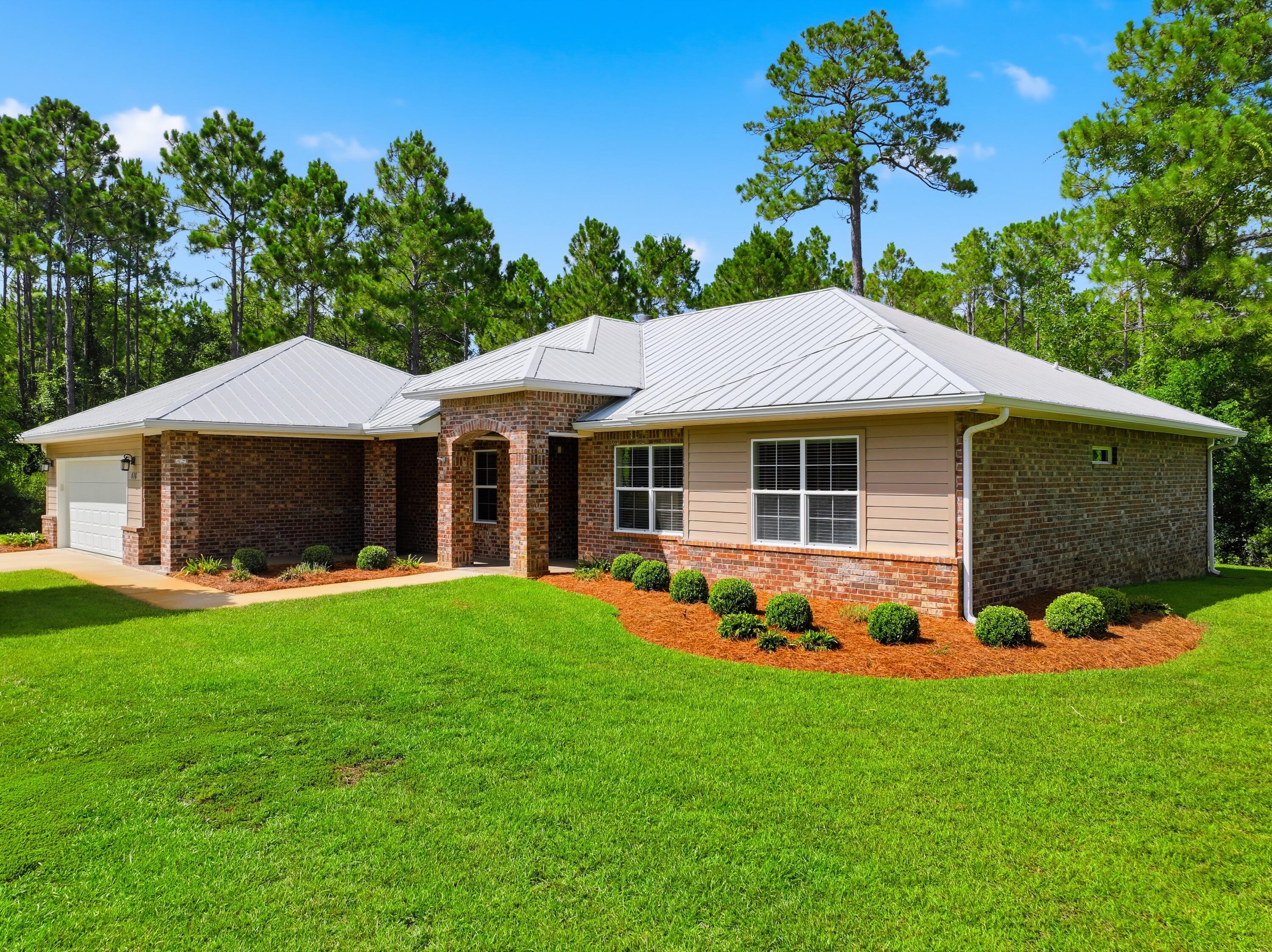 Tucked behind the gates of Seclusion Bay, this inviting single-level home offers privacy and relaxed coastal living on more than half an acre. The thoughtfully designed three-bedroom, two-bath floor plan features approximately 1,955 square feet with an open, comfortable flow, hardwood flooring and a welcoming living area centered around a fireplace. The spacious master suite includes a double vanity, tiled bath, and large closet, while two additional bedrooms offer flexibility for guests, or a home office.

Outside, the expansive yard provides plenty of room to relax, entertain or create a private outdoor retreat. A large deck, attached garage, metal roof and timeless brick and hardi-board exterior add both function and curb appeal. Residents of Seclusion Bay enjoy gated entry, a community dock and all within convenient reach of the white-sand beaches, restaurants, shopping and entertainment along Scenic Highway 30A. This is a rare opportunity to enjoy a peaceful neighborhood setting while remaining close to everything that makes Santa Rosa Beach special.