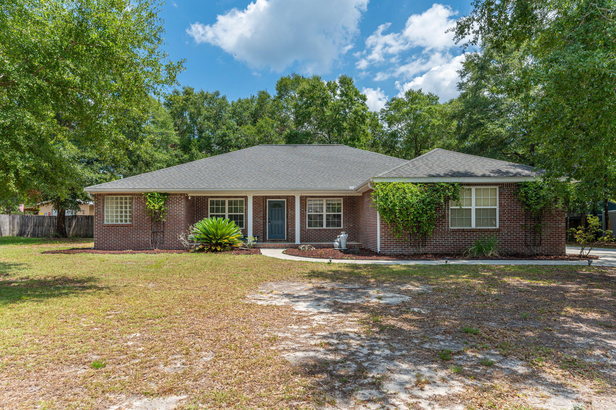 One acre lot with NO hoa, this beautiful all-brick home offers the room you've been looking for--both inside and out. Split bedroom floor plan is complemented by beautiful lvp and tile flooring throughout-NO carpet, creating a timeless look with the added benefit of easy maintenance. Vaulted ceilings in the living room, formal dining room, indoor spacious laundry, breakfast room and huge luxury kitchen round out the living area. Kitchen features a large center island, breakfast bar, double ovens, abundant cabinetry, granite counters and recessed lights. Outside, your private backyard retreat awaits. Covered porch and the fully fenced backyard on this one-acre property provides endless possibilities for outdoor living, gardening, pets, recreation, or simply enjoying the extra space and privacy. Gather around the outdoor fireplace on cool evenings, and take advantage of the storage shed for tools and equipment. Additional highlights include a two-car garage, an extra-long driveway with plenty of parking, and the low-maintenance durability and classic curb appeal of a brick exterior.Conveniently located in the back of a quiet community with wooded surround, with easy access to the military base, as well as shopping, dining, and everyday amenities around town, this home combines peaceful living with an ideal location. If you've been searching for space, functionality, and a property that feels like a breathe of privacy, this is it. Roof: 2025 HVAC:2015  Water Heater:2019