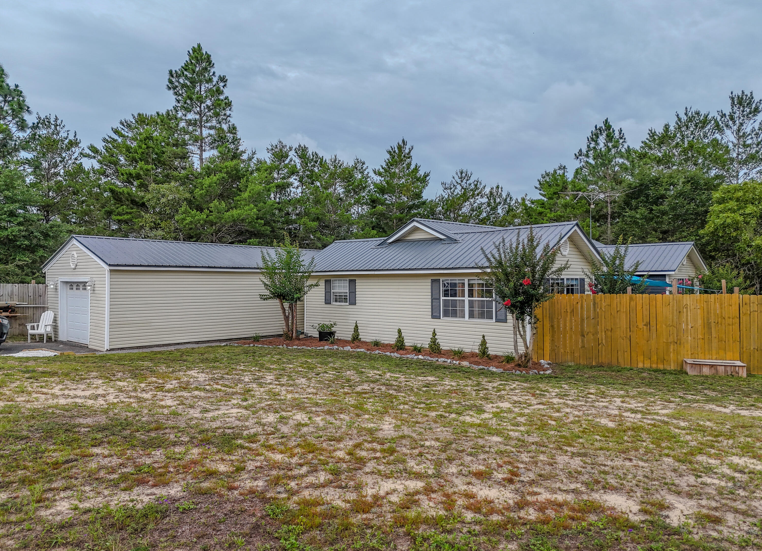 Turn key, move in ready home in the fast growing Mossy Head area. This 4 bedroom 2 bath home has over 2200 square feet of living space on a generous almost half acre lot. This home is set up great for multi-generational living with 2 master suites. The home features a split floor plan with eat-in kitchen and large panty area. Outside there is a carport with upstairs storage room and privacy fenced yard. The metal roof was installed in 2024 and HVAC is 2016.
Conveniently located just 6 miles from I-10, 41 miles to Eglin AFB and 20 miles to Crestview, this home makes commuting a breeze.