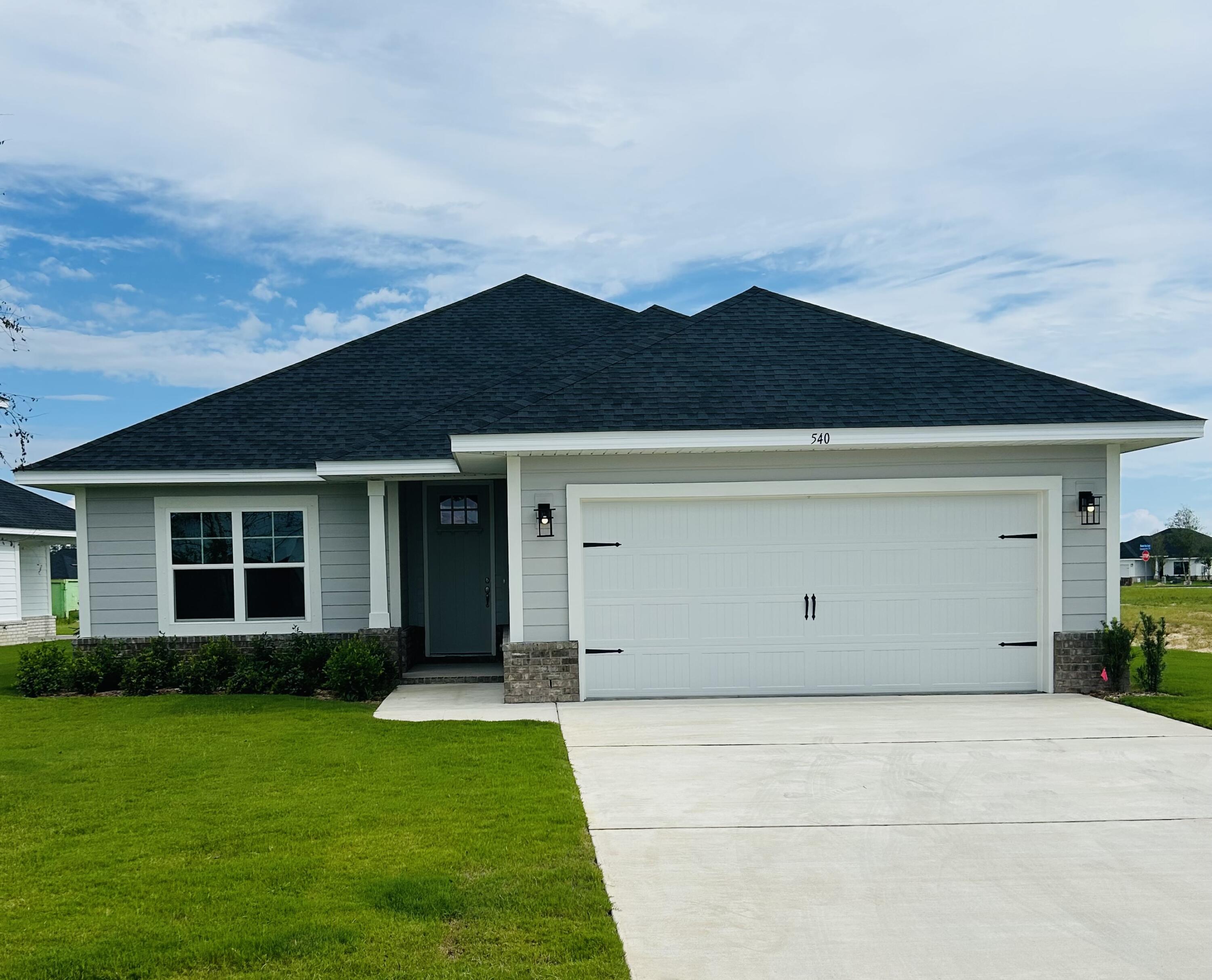 This popular Craftsman-style 3BR/2BA home (currently under construction: (Est. June/July completion) is ideally located close to the entrance of the community (next to model). Designed with both comfort and style in mind, the home features HardieBoard® siding with a brick skirt, 9' ceilings, 8' entry doors, and CoreTec Pro Plus luxury vinyl plank flooring throughout--no carpet. The spacious primary suite boasts elegant tray ceilings, a generous walk-in closet, and a spa-inspired bath. Quartz countertops in the kitchen and baths, soft-close cabinetry, spacious covered patio & wood burning fireplace complete this inviting home, perfect for relaxed everyday living and entertaining. *Pics are of a similar home.*  Ask about 4.99% fixed rate plus Move in Ready package!