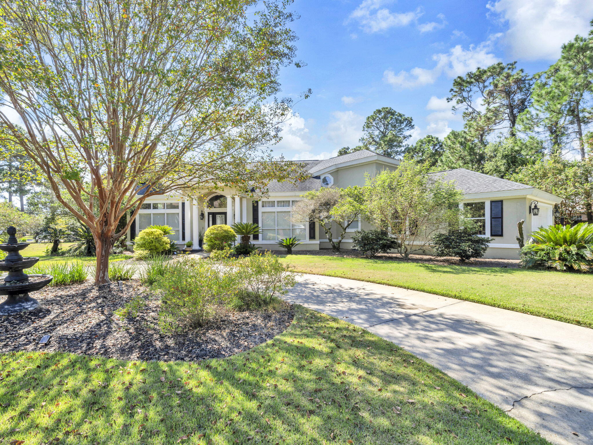 Move in ready 4-bedroom 3 bath home in the gated community of Southwind in Bluewater Bay.  The remodeled kitchen has granite counter tops, wood cabinets, stainless steel appliances, walk-in pantry, & island with storage.  The family room is right off the kitchen for open concept living.  The living room has high ceilings, a fireplace, curved staircase to the second floor and is  open to the large dining room. There is custom trim work throughout the home. In addition, this fabulous home has a screened in porch with outdoor kitchen area, and a heated and cooled Florida room on the first level.  3 bedrooms up including spacious primary and 2 renovated baths up, 2 car attached garage, circular drive, laundry room with sink. Large corner lot with firepit, pergola and beautiful plantings with plenty of room for a pool. Bluewater Bay has a pool right around the corner along with golf, tennis and pickleball.