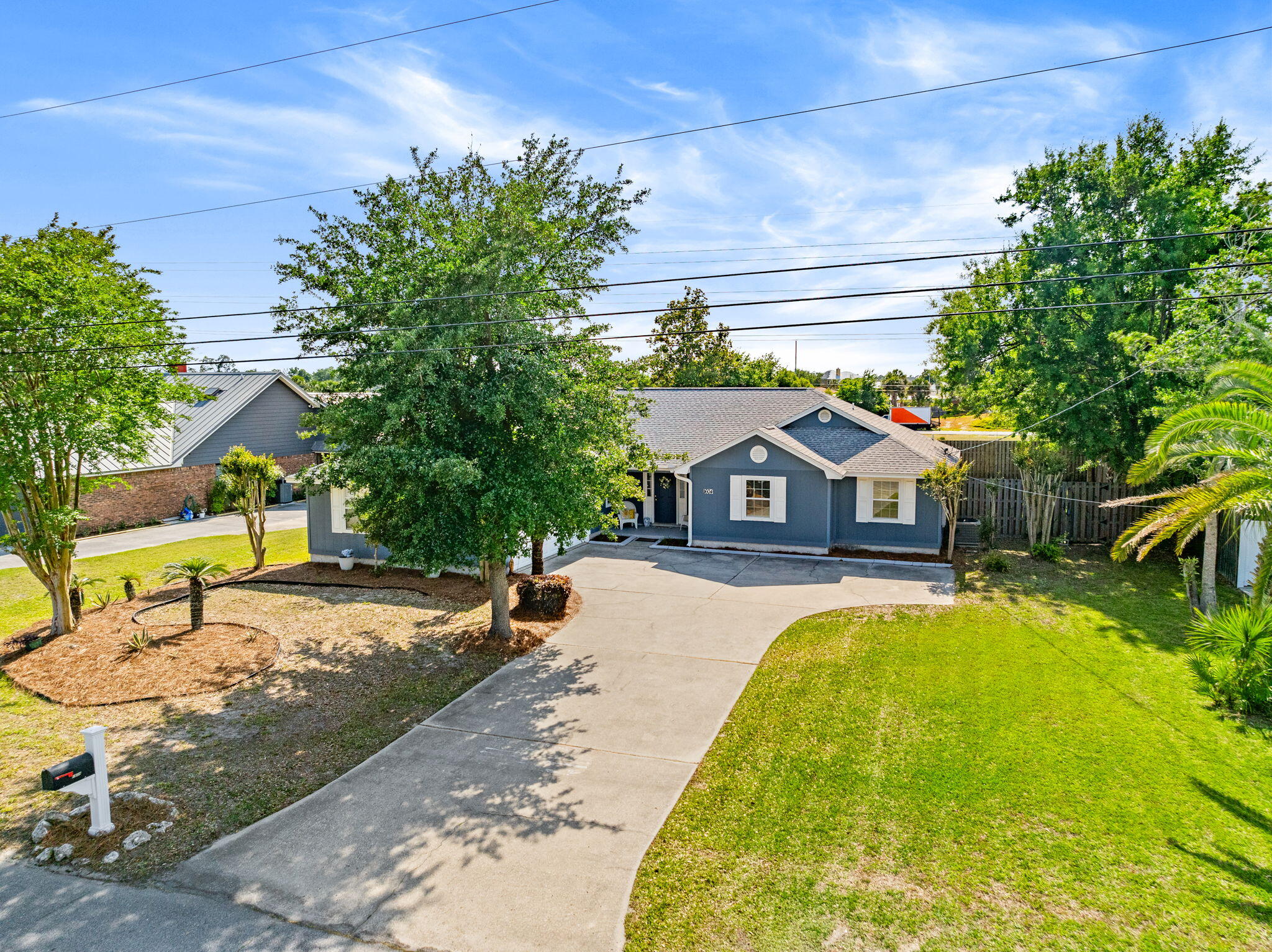 Welcome to this beautifully maintained home located in the desirable Northshore area of Lynn Haven, approximately half a mile from North Bay. Situated on a spacious 0.344 acre fully fenced lot, this property offers almost 2000 sqft with 3 Bedrooms plus an Office/Bonus Room, along with a bright Florida room filled with natural light. The backyard is designed for enjoying the Florida lifestyle with an open deck and a shop/shed building providing additional storage or workspace. Inside, the home features beautiful vinyl plank flooring throughout and abundant natural lighting in every room. The spacious kitchen offers stainless steel appliances, including a gas stove and newer refrigerator, along with ample cabinet and counter space. The open living room includes an electric fireplace, creating a warm and inviting gathering space. The primary suite features bay windows, a walk in closet, and an ensuite bathroom with dual sinks and vanity. Additional updates include a roof replaced in 2019, gas water heater installed in 2024, HVAC system replaced in 2020, and newer windows installed within the last few years. Home is on Public water and a Septic (septic pumped in 2020 for regular maintenance and upkeep). The HVAC system has also been regularly serviced and maintained annually. Located in the Northridge community, residents enjoy a golf cart friendly neighborhood in the heart of Lynn Haven.