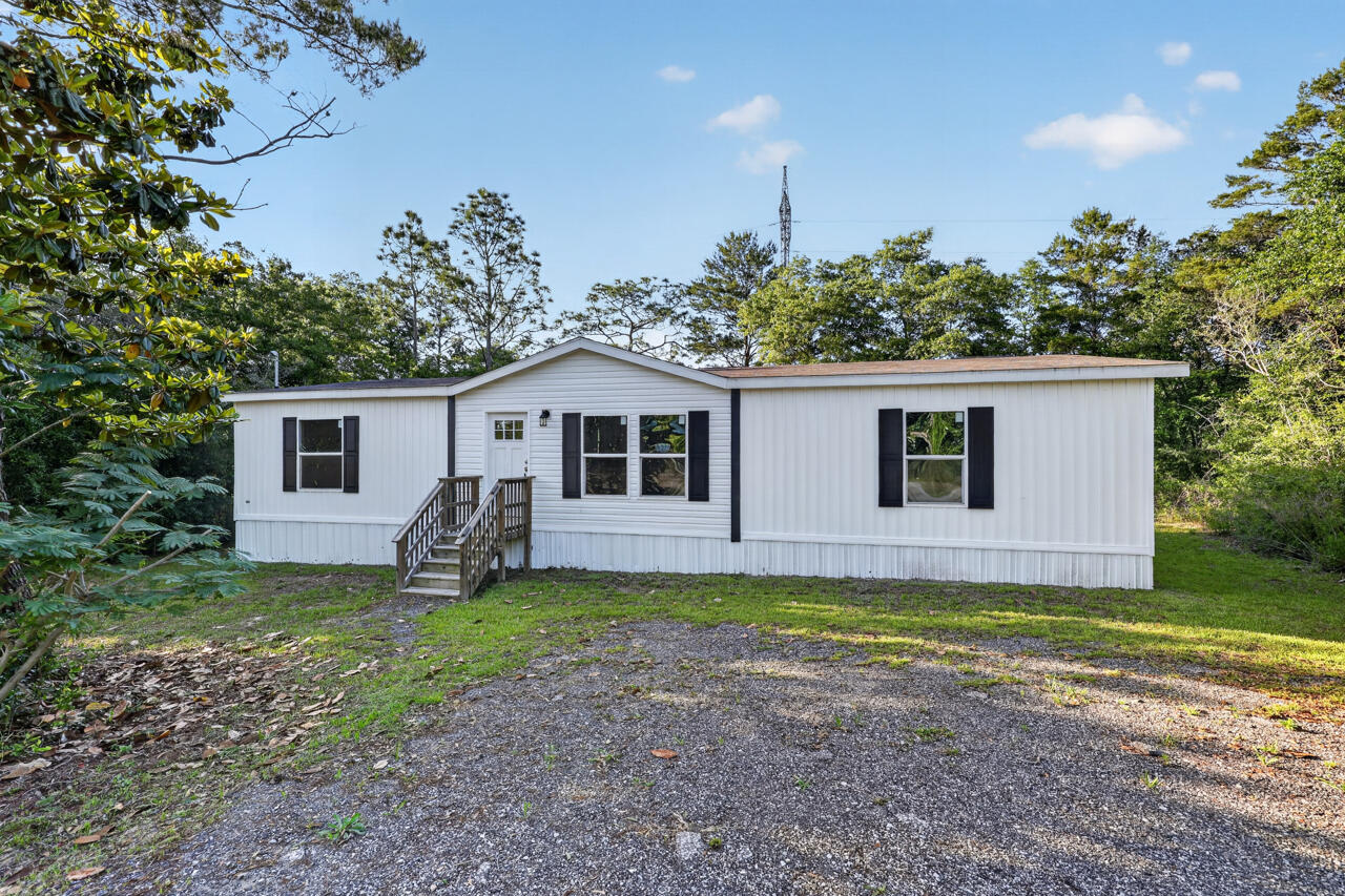 Short-sale opportunity in DeFuniak Springs. This 2022 manufactured home offers 3 bedrooms, 2 baths, and 1,512 sq ft of thoughtfully designed living space on a .23-acre wooded homesite. Located just across the street from Beaver Dam Park, a waterfront park with bathrooms, benches, and recreational areas, this property offers a peaceful setting with outdoor enjoyment close to home.

Inside, the open-concept layout creates an easy flow between the living area, dining space, and kitchen. The kitchen features a large island, making it a natural gathering place for everyday living and entertaining. New vinyl plank flooring has been added in the dining area, guest bath, and two bedrooms, while Lux Low E thermo-pane windows bring in natural light and fold down for easy maintenance.

Centrally located between DeFuniak Springs and Crestview, this home offers convenient access to daily needs, local services, and nearby employment centers. Eglin AFB is approximately 45 minutes away, and Florida's Emerald Gulf Coast white sandy beaches are close enough for an easy day trip.

With no HOA and minimal restrictions, this property offers flexibility for first-time buyers, military buyers, or anyone looking for space, comfort, and convenience in a relaxed setting. Schedule your private showing today.