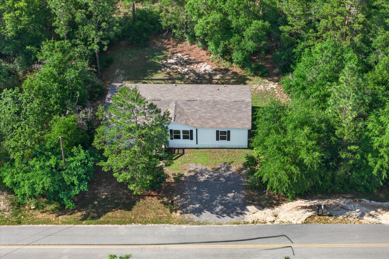 Short-sale opportunity in DeFuniak Springs. This 2022 manufactured home offers 3 bedrooms, 2 baths, and 1,512 sq ft of thoughtfully designed living space on a .23-acre wooded homesite. Located just across the street from Beaver Dam Park, a waterfront park with bathrooms, benches, and recreational areas, this property offers a peaceful setting with outdoor enjoyment close to home.

Inside, the open-concept layout creates an easy flow between the living area, dining space, and kitchen. The kitchen features a large island, making it a natural gathering place for everyday living and entertaining. New vinyl plank flooring has been added in the dining area, guest bath, and two bedrooms, while Lux Low E thermo-pane windows bring in natural light and fold down for easy maintenance.

Centrally located between DeFuniak Springs and Crestview, this home offers convenient access to daily needs, local services, and nearby employment centers. Eglin AFB is approximately 45 minutes away, and Florida's Emerald Gulf Coast white sandy beaches are close enough for an easy day trip.

With no HOA and minimal restrictions, this property offers flexibility for first-time buyers, military buyers, or anyone looking for space, comfort, and convenience in a relaxed setting. Schedule your private showing today.