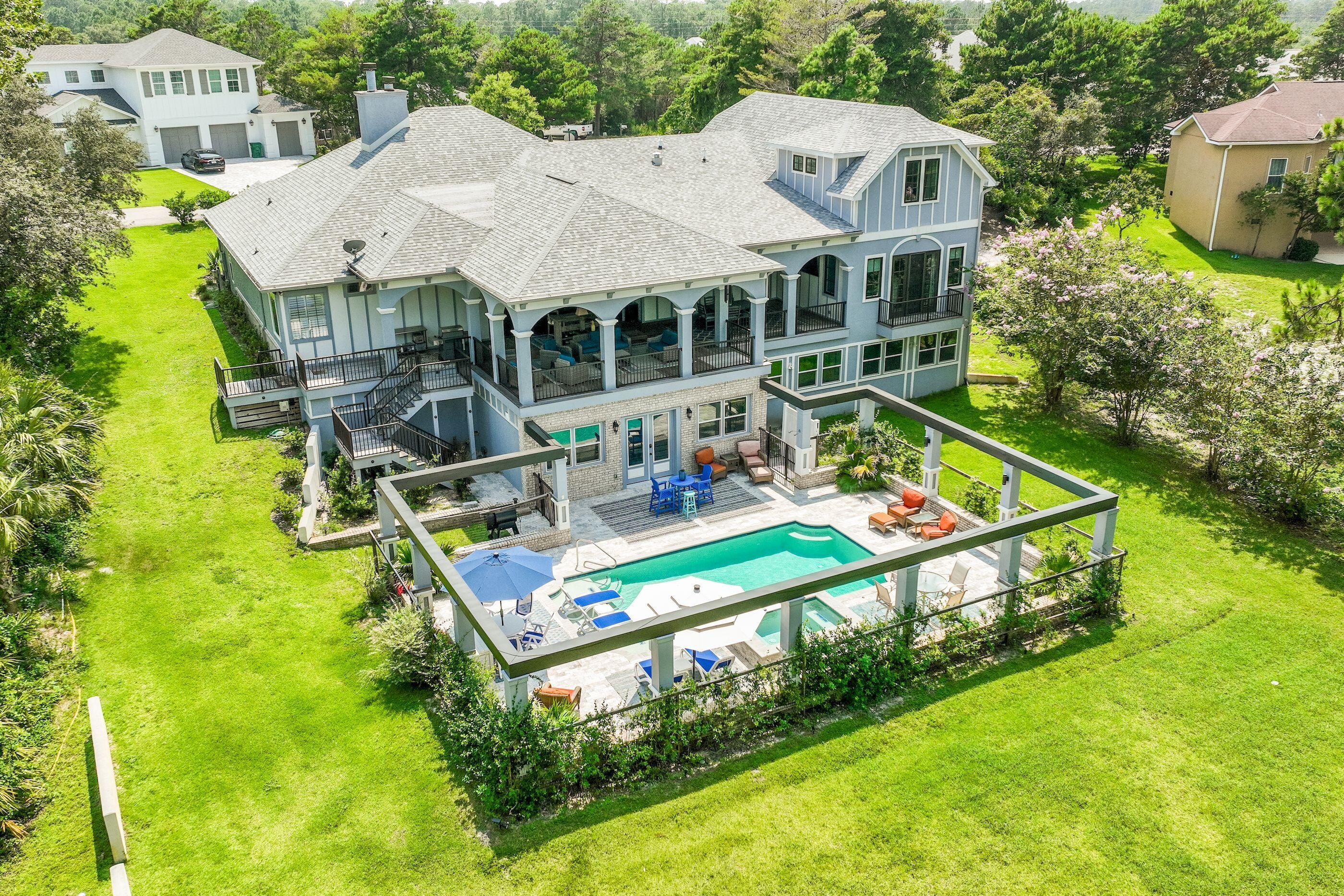 Discover an exceptional retreat where craftsmanship meets lakefront living. Perfectly positioned on Anchors Lake Dr., just minutes from the SRB golf course and the sugar-white beaches of 30A, this custom residence offers over 4,600 square feet of thoughtfully designed living space with expansive water views and a generous 1,200 Sq. Ft. outdoor covered patio, and refined finishes throughout. A chef's custom kitchen, 2 spacious primary suites for private guest accommodations, a heated pool and spa, and an oversized 3-car garage create the ideal setting for everyday luxury or entertaining. Nestled within an exclusive neighborhood that prohibits short-term rentals, this home offers privacy.