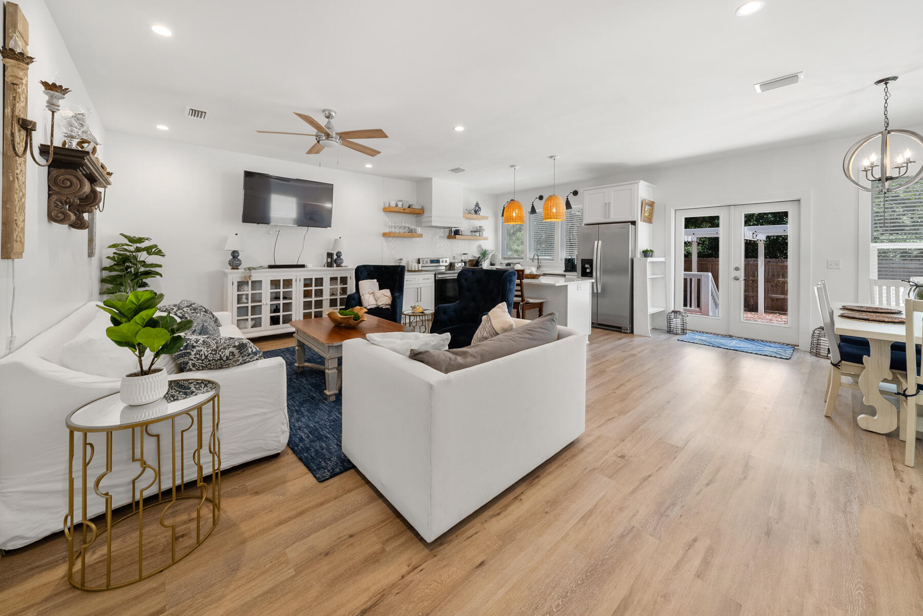 Built in 2021, this beautifully maintained 4-bedroom, 3-bathroom home offers modern coastal living with thoughtful upgrades throughout. Upon entering, you are welcomed by a spacious open-concept layout that seamlessly connects the living, dining, and kitchen areas, creating an inviting atmosphere ideal for both everyday living and entertaining. Stylish modern finishes and tasteful décor enhance the home's light and airy ambiance.

The kitchen is designed to impress, featuring granite countertops, white shaker-style cabinetry, stainless steel appliances, and a large island with breakfast bar seating. Luxury vinyl plank flooring extends throughout the home, offering both durability and low-maintenance living--perfect after a day at the beach. Raised ceilings and an abundance of windows fill the interior with natural light, further enhancing the home's bright and open feel.

The first-floor primary suite provides a private retreat with an ensuite bathroom featuring a double vanity and a spacious walk-in closet.

Ideally situated in a central location, this home is approximately ¼ mile from Cessna Landing, providing convenient access to the public boat launch into Hogtown Bayou. Enjoy being just a short drive from local dining, shopping, entertainment, and the area's beautiful beaches, making this an exceptional primary residence, vacation home, or investment opportunity.