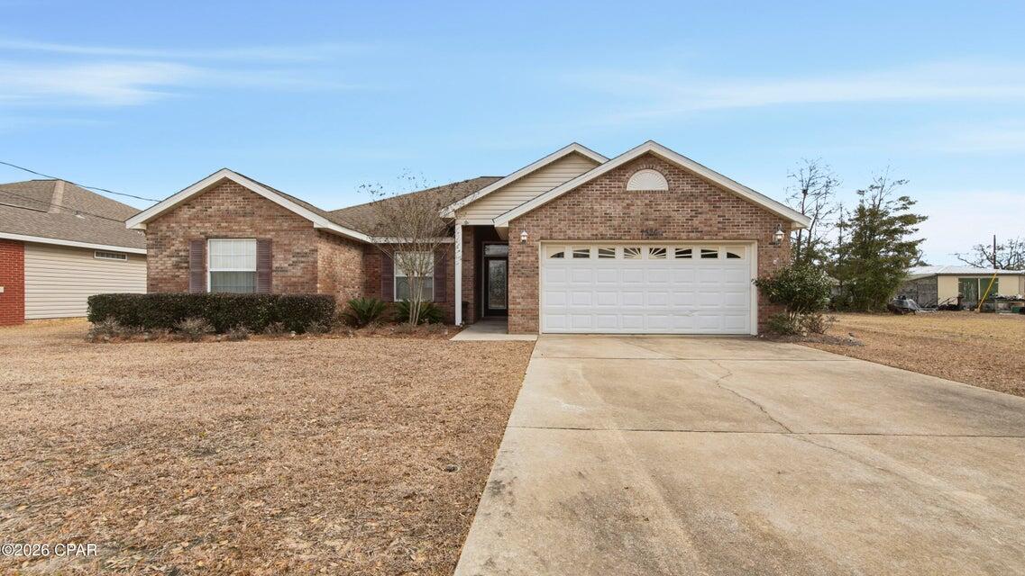 'CURRENTLY UNDER CONTRACT, SELLER WILL CONSIDER BACKUP OFFERS' Welcome to 7526 N. Gainer Bayou Rd in Southport, FL 32409 -- a charming home that perfectly blends peaceful North Bay living with convenient access to everything Lynn Haven has to offer. Enjoy quiet surroundings while being just minutes from the shops, restaurants, coffee spots, and grocery stores along Hwy 77 and Hwy 390, including Publix, Winn-Dixie, and everyday essentials, giving you the best of both worlds: privacy and convenience. The home greets you with a classic solid brick front exterior that offers timeless curb appeal and low-maintenance durability, along with a spacious two-car garage and a welcoming patio ideal for relaxing or entertaining. The partially fenced backyard provides room for pets, play, or gardening, and the backyard shed adds valuable extra storage or space for tools, hobbies, and lawn equipment. Inside, the home features durable luxury vinyl plank flooring throughout the main living areas, a cozy fireplace perfect for cooler evenings, elegant crown molding, and a spacious primary suite highlighted by a trey ceiling that adds architectural character. The kitchen is bright and functional with Formica countertops and stainless steel appliances, creating a practical and stylish space for everyday living. Buyers will appreciate the peace of mind that comes with major updates already completed, including a brand new water heater installed in 2026 and a roof replaced in 2018. With its comfortable features, valuable updates, and convenient location near Lynn Haven's shopping, dining, and daily conveniences, this home offers the lifestyle and value today's buyers are searching for. Furniture items in the home are negotiable with the sale.