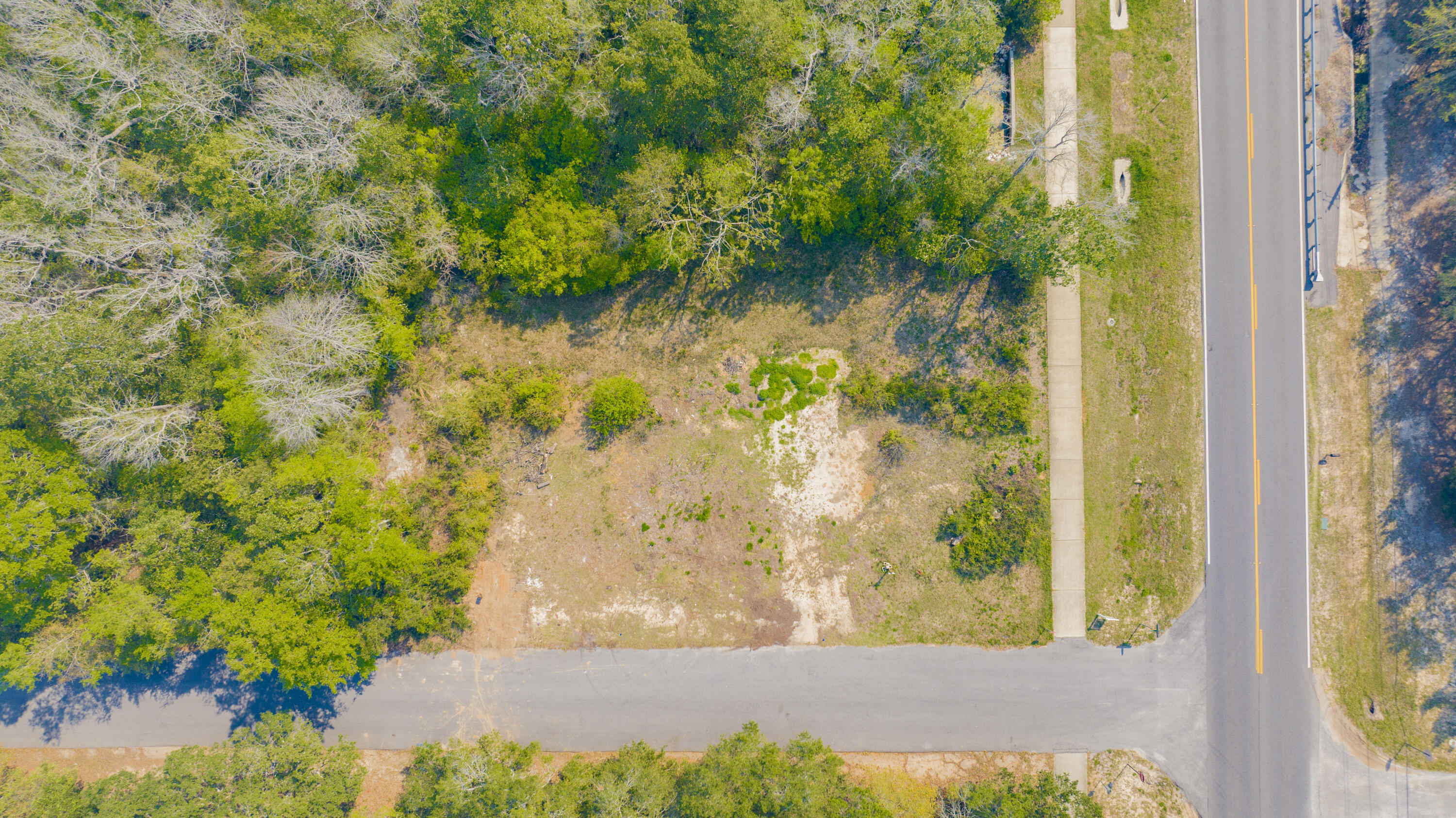 Nestled on a mostly cleared corner lot in a peaceful cul-de-sac just off the beautiful East Bay, this property offers an ideal setting to build your dream home. With public water and electricity already in place, it's ready for construction to begin. Conveniently located near Navarre Beach, you'll enjoy quick access to sun, sand, and coastal living. Plus, you're just a short drive from local restaurants, shopping, and schools, giving you both tranquility and everyday convenience.