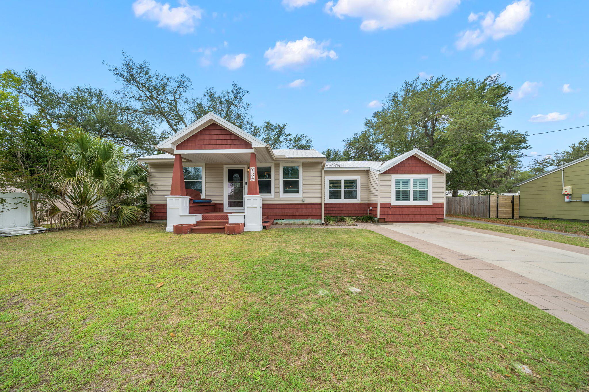 Under contract with 72-Hour Kick-Out Clause. Across from the Bay in the historic Cove neighborhood sits a home exuding charm and character offering 3 bedrooms, 2.5 baths, a detached home office with an adorable front porch! 

This Cove cottage features almost 1800 square feet of living space with a large open deck on the back, overlooking the shaded back yard, perfect for entertaining. You're greeted with a cozy, covered front porch and enter into a stunning great room with custom millwork throughout including a stunning coffered ceiling flowing throughout the living room, kitchen and dining area. The living room is flooded with natural light, spacious and includes a separate area great for kids to play or would function as a great conversation area. The kitchen is outfitted with beautiful granite countertops, stainless steel appliances and a gas cooktop with accent lighting above the cabinetry. The dining room overlooks the backyard with lush oak trees. 

Just off the kitchen is a guest bedroom with en suite bath complete with a tub/shower combo. An additional guest bedroom is found toward the back of the home off the dining room. A great feature of this home that is rare in Cove homes is a half bath which is in an excellent location for guests - just off the living room area. The hallway with the powder room leads to the primary suite which is a true retreat! The primary suite includes double closets, vaulted ceilings, natural light and a en suite bath to include a dual shower head, oversized tiled shower, double vanities and water closet. This home is a true split floor plan! 

One of the best features of this home is the building in the backyard. This 2023-built permitted outbuilding has a home office complete with plumbing and electrical and a half bath. This is an incredibly desirable feature for those who wish to work at home but be separated from the home for work. The outbuilding also has a work shop area great for hobbies and outdoor work. This building is also insulated for temperature control and encapsulated to keep it free from pests. The right side of the home also gives access to a city-maintained alley that runs along the back yard fence and gives easy access for trailers, boats, etc. 

1604 Tyndall Drive offers a 2020 roof, 2019 windows, 2020 HVAC, tankless water heater, whole house surge protector, Aquasauna water filtration system (complete with 6 months of filters!) and 2017 Maytag appliances. The Cove is a charming golf cart-friendly community with NO HOA and highly sought after for it's water views as well as its city-maintained playgrounds and parks. Just 2 homes down from this home you'll also enjoy a baseball field and new playground area for kids and families. Enjoy events in the community throughout the year! This neighborhood is adjacent to the fast-growing downtown Panama City area which features restaurants, a marina, shopping, breweries, farmers markets and events year-round. The St. Andrews Bay Yacht Club is an incredible offering as an addition amenity in the neighborhood and just a few minutes away. Ideal for boaters, fisherman and those who love to enjoy events, as a member, you will enjoy access to a private boat launch, dining waterfront and activities weekly. 1604 Tyndall Drive in the heart of the Cove is waiting for you!