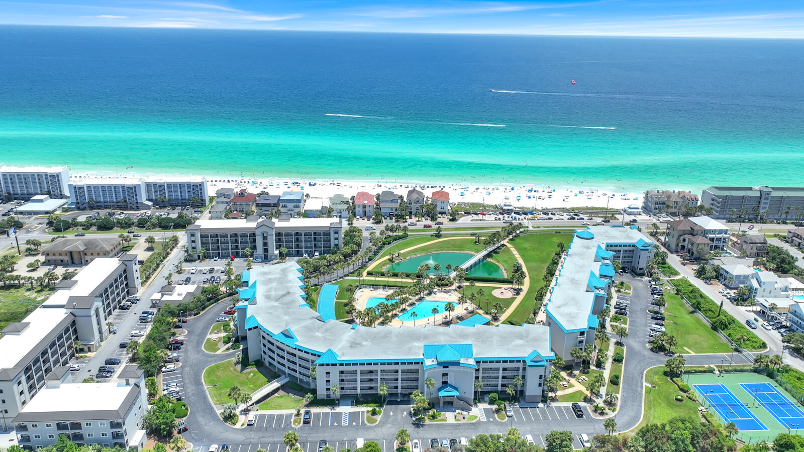 Welcome to the ultimate coastal sanctuary at the prestigious, gated Amalfi Coast Resort! This stunning, fully furnished, turnkey 2-bedroom, 2-bathroom residence features the largest 2-bedroom floor plan in the entire community, offering an impressive 1,410 sq. ft. of pure beachside luxury. From the moment you step inside, you'll be captivated by the bright, airy open-concept layout, beautifully accented by modern Luxury Vinyl Plank flooring. The spacious living area flows seamlessly onto an expansive 160 sq. ft. private balcony, where you can bask in breathtaking, panoramic views of the shimmering emerald Gulf waters--the perfect backdrop for morning espresso or sunset cocktails. The sleek kitchen comes fully equipped with stainless steel appliances, making entertaining a breeze, while an oversized laundry room provides unmatched convenience. Perfect as a lucrative, rent-ready vacation investment or your own private slice of paradise, this unit also includes a highly coveted assigned garage parking space and storage unit for all your beach equipment. Set within a lush, tropical oasis along Scenic Gulf Drive, Amalfi Coast Resort treats you to sparkling community pools and effortless beach access. This isn't just a condo--it's a lifestyle!