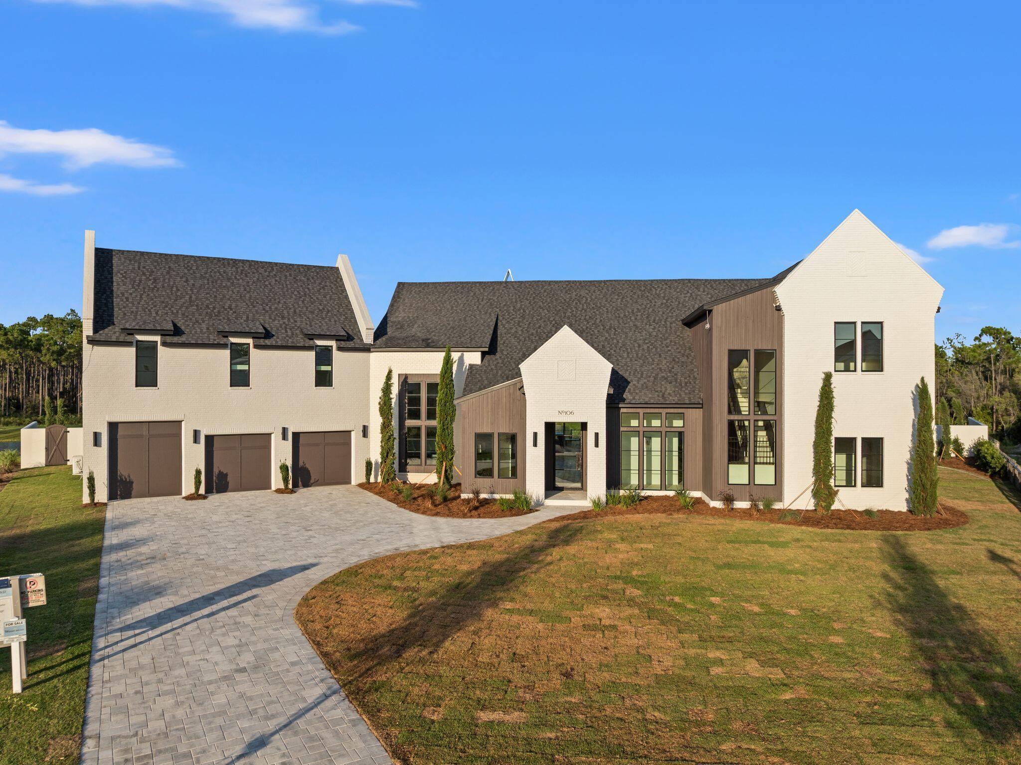 Welcome to 106 S Southern Cross Lane, an exceptional newly constructed estate tucked away on a private half-acre cul-de-sac lot in the prestigious Camp Creek community of Watersound. Overlooking a tranquil pond, this remarkable five-bedroom, five-and-a-half-bath residence seamlessly blends timeless architecture, designer finishes, and resort-style living.

A grand entry welcomes you with limestone flooring, soaring 12-foot barrel ceilings, dramatic floor-to-ceiling windows, and striking custom light fixtures that fill the home with natural light. Every detail has been thoughtfully curated to create an atmosphere of understated luxury.

Designed for both everyday living and effortless entertaining, the chef's kitchen features premium appliances, stunning Taj Mahal quartzite countertops, an impressive 12-foot island, and an oversized scullery complete with an additional refrigerator, freezer, full wine refrigerator, coffee bar, and abundant storage. Adjacent to the kitchen, a spectacular backlit Cristallo stone feature wall anchors the custom wet bar, complete with a sink and ice maker, creating an unforgettable focal point.

The expansive living room showcases soaring beamed ceilings, a custom stone fireplace, and a full wall of sliding glass doors that open to an incredible outdoor living space. Designed for year-round entertaining, the backyard features a covered summer kitchen, resort-style pool and spa, fire pit, and peaceful pond views. The luxurious primary suite is a private retreat with vaulted beamed ceilings and picturesque water views. The boutique-inspired dressing room offers floor-to-ceiling custom cabinetry, while the spa-like primary bath is finished with elegant plaster walls, a soaking tub, and an oversized walk-in shower, creating a true sanctuary.

Three additional spacious en suite bedrooms are thoughtfully positioned on the main level, providing exceptional comfort and privacy for family and guests. A dramatic floating staircase leads to the second floor, where an additional en suite bedroom is complemented by an oversized recreation room offering endless possibilities as a media room, golf simulator, game room, fitness space, or custom bunk room.

As a homeowner in Watersound Camp Creek, enjoy exclusive membership to the unparalleled Watersound Club lifestyle, including the Camp Creek amenities and the Beach Club. Members have access to four world-class golf courses, tennis and pickleball facilities, resort-style pools, wellness amenities, exceptional dining, and private beach access along the Emerald Coast.

Offering extraordinary craftsmanship, exceptional design, and an unmatched lifestyle, this newly completed Camp Creek residence represents one of the finest luxury opportunities