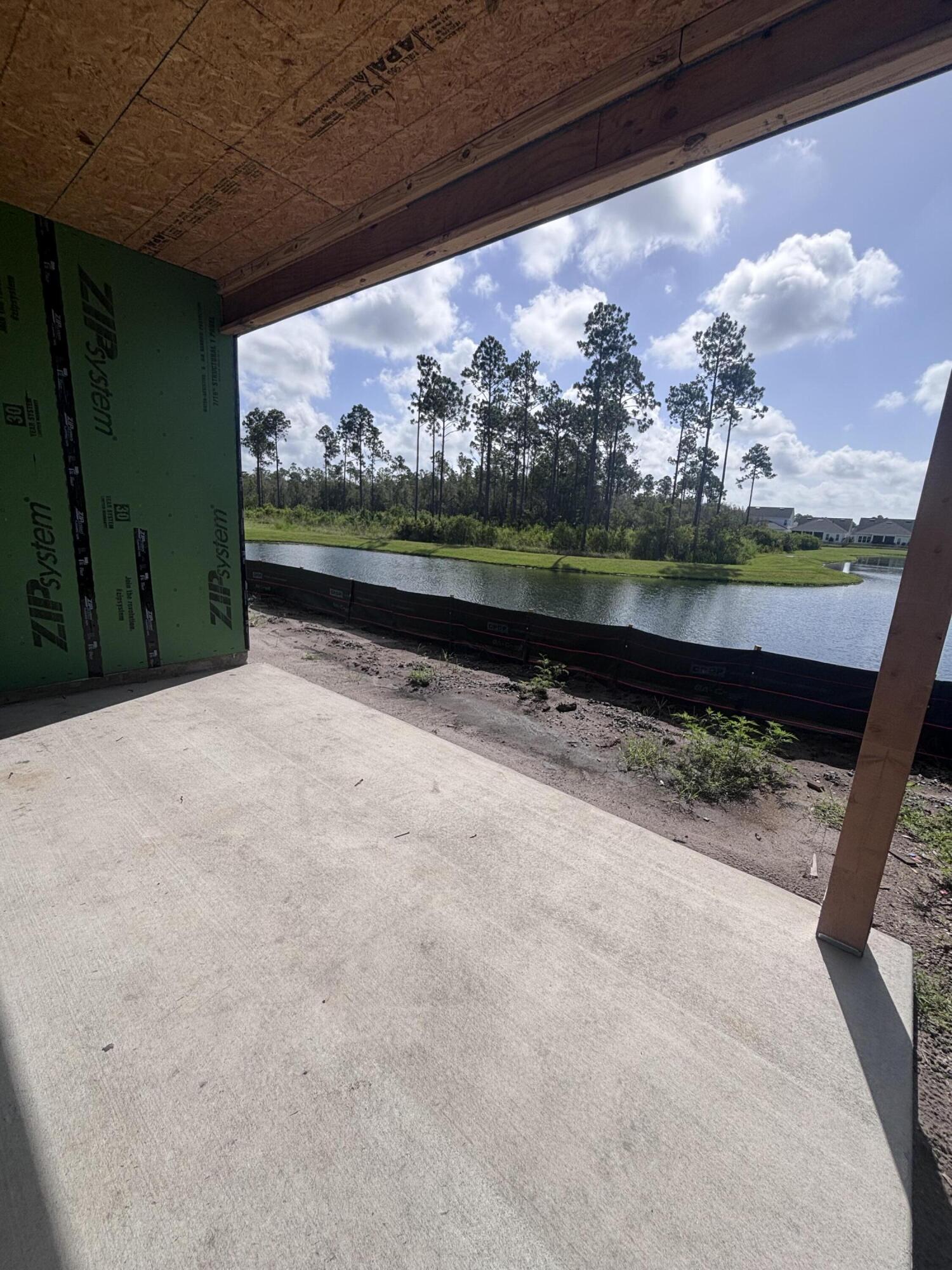 The Lucas plan offers 1,418 square feet, 2 bedrooms, 2 bathrooms, and a 1.5-car garage in the Villas at Longleaf Park within the Watersound Origins community. Situated on a pie-shaped homesite overlooking a retention pond, this paired patio home enjoys an open water view from the rear covered patio, enhanced by a professionally engineered retaining wall that creates a more defined outdoor living space. Estimated completion is October/November 2026.

Designed for easy, low-maintenance living, the open floor plan brings together the kitchen, dining, and family room beneath 10-foot ceilings with 8-foot interior doors throughout. Large rear windows and direct access to the covered patio maximize natural light while framing views of the pond. The spacious kitchen features upgraded soft-close cabinetry, Level 3 quartz countertops, an upgraded tile backsplash, a walk-in pantry, and an upgraded GE appliance package with built-in appliances, a 5-burner gas cooktop, and upgraded hood. Luxury vinyl plank flooring extends throughout the home, complemented by impact-rated windows, a tankless water heater, craftsman-style trim with 5¾-inch baseboards, and a Smart Home package.

Privately positioned at the rear of the home, the owner's suite includes a generous walk-in closet and an ensuite bath with Level 3 quartz countertops. The secondary bedroom is located near the front of the home adjacent to a full guest bath featuring an upgraded ceramic tile surround, The covered patio overlooks the pond and retaining wall, creating a comfortable outdoor setting for relaxing or entertaining while enjoying the water view. Lawn maintenance is included, allowing for a lock-and-leave lifestyle.

Located in the Longleaf Park neighborhood of Watersound Origins, residents are just minutes from Watersound Town Center, Publix, restaurants, medical offices, and convenient access to Hwy 98. Community amenities include the Origins Golf Course, Village Commons pool and fitness center, sports courts, and an extensive network of walking and biking trails.