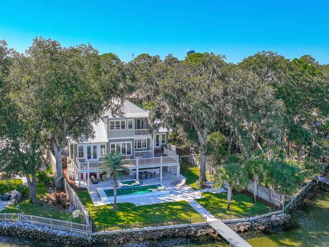 This bayfront home offers the best of coastal living with breathtaking views of Choctawhatchee Bay and a light-filled, open design. Upon entry, you're welcomed into a spacious living area where large windows showcase the water and create an airy, inviting atmosphere.

The open-concept layout flows effortlessly from the living and dining areas into a well-appointed kitchen, making it ideal for both everyday living and entertaining.

The home features four generously sized ensuite bedrooms, providing comfort and privacy for family and guests. Two primary suites include private balconies and panoramic bay views, offering a peaceful place to unwind at the end of the day.

Step outside to a beautifully designed outdoor living space with an expansive deck, saltwater pool, and hot tub --perfect for hosting gatherings or enjoying quiet evenings watching dolphins and overlooking the water.

A covered 10,000 lb boat lift allows for easy access to the bay, making this property a true waterfront retreat with a seamless blend of indoor comfort and outdoor enjoyment.