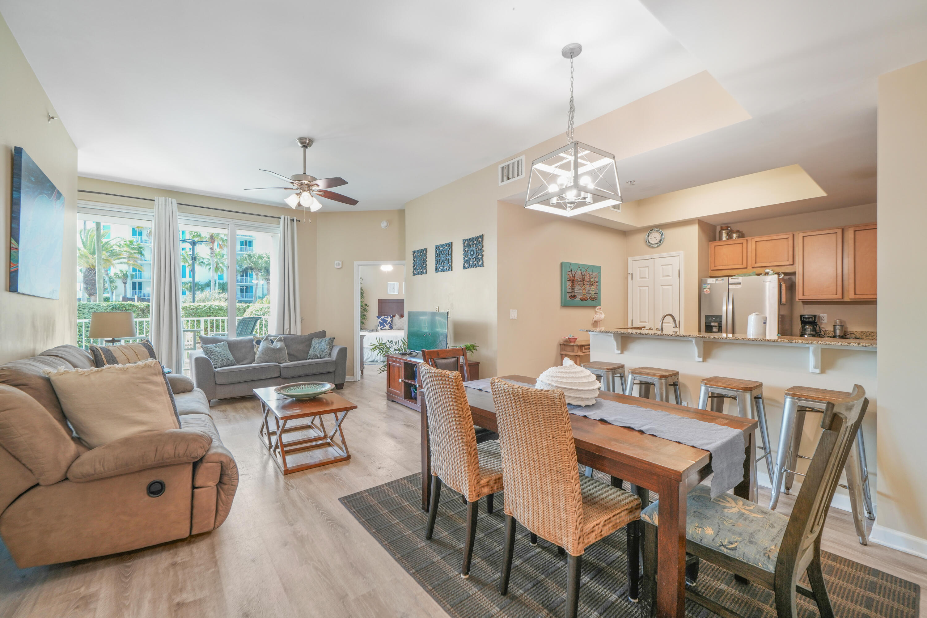 Welcome to Unit 1115 at The Palms of Destin where effortless coastal elegance meets resort-style living in the heart of Destin and less than a half mile from the white sugary sands of the Emerald Coast.  Perfectly positioned as a rare ground-floor, corner end-unit with 10' ceilings, this condo can be used as a turn-key investment (short-term or long-term), second home, or primary residence and projects between $35-55k annually.  Everything conveys.

This beautifully appointed 2-bedroom, 2-bath residence invites you into a light-filled, open-concept space designed for both relaxation and entertaining. From the moment you step inside, you'll notice fresh modern finishes, and coastal-inspired palette of soft whites, blues, and sandy neutrals creating a serene, beachside ambiance throughout. You'll notice beautiful paintings and these are original artwork painted by a previous owner and they stay with the home.
The kitchen flows seamlessly into the dining and living areas, highlighted by designer lighting and thoughtful touches that make the space feel both elevated and inviting. The fridge is newer and offers an ice-maker on the exterior freezer door.  
Both bedrooms feature king-sized accommodations, offering comfort and privacy for owners and guests alike. 

What truly sets this residence apart is its expansive private patio with three separate access points from the living room and both bedrooms creating an effortless indoor-outdoor lifestyle. 
The water heater and HVAC are less than 4 years old.  

Whether you're seeking a turnkey investment, second home, or full-time residence, this condo delivers with rental-ready furnishings, newer LVP flooring and tile in bathrooms and kitchen, and a layout designed for both comfort and income potential.  ALL items convey (everything you see in photos including furniture, appliances, kitchenware, electronics, artwork - except linens - they belong to the current property manager). 
COA fees cover water, electric, internet, TV, and trash so basically all utilities, including access/upkeep of all amenities at the Palms.

Step outside and you're just moments from the resort's stunning 11,000 sq ft lagoon pool, giving this unit a true "walk-out resort" feel that guests and owners absolutely love.
Residents and guests of The Palms of Destin enjoy an unmatched suite of amenities, including:
* A spectacular lagoon-style pool, heated pool, spa, and splash pad
* On-site restaurant, bar, and coffee shop
* Tennis, pickleball, and basketball courts
* 24-hour fitness center and playground
* Seasonal shuttle service to the beach, HarborWalk Village, and Destin Commons
* Covered parking, EV charging stations, and nearby dog park
Located less than 1/2 a mile from the sugar-white sands and emerald waters of the Emerald Coast, this is more than a property, it's your gateway to the Destin lifestyle.  Opportunities like this ground-floor, corner end-unit, walk-out to the pool are incredibly rare.  Schedule your private showing today and experience it for yourself.